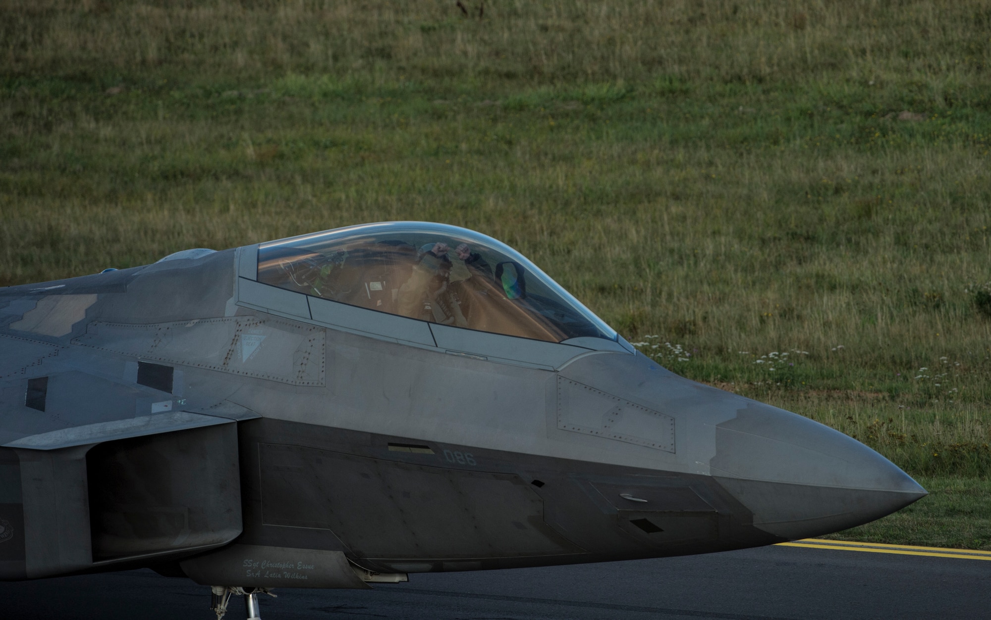 A U.S. Air Force F-22 Raptor fighter aircraft pilot assigned to the 95th Fighter Squadron at Tyndall Air Force Base, Fla., celebrates landing at Spangdahlem Air Base, Germany, Aug. 28, 2015. This is the first training deployment of the F-22 Raptor in the U.S. European Command theater. The U.S. values the shared commitment and close cooperation with NATO allies on countering a range of regional and global threats. The USAF’s forward presence in Europe allows training with U.S. allies and partners to develop and improve regional security. (U.S. Air Force photo by Staff Sgt. Christopher Ruano/Released)