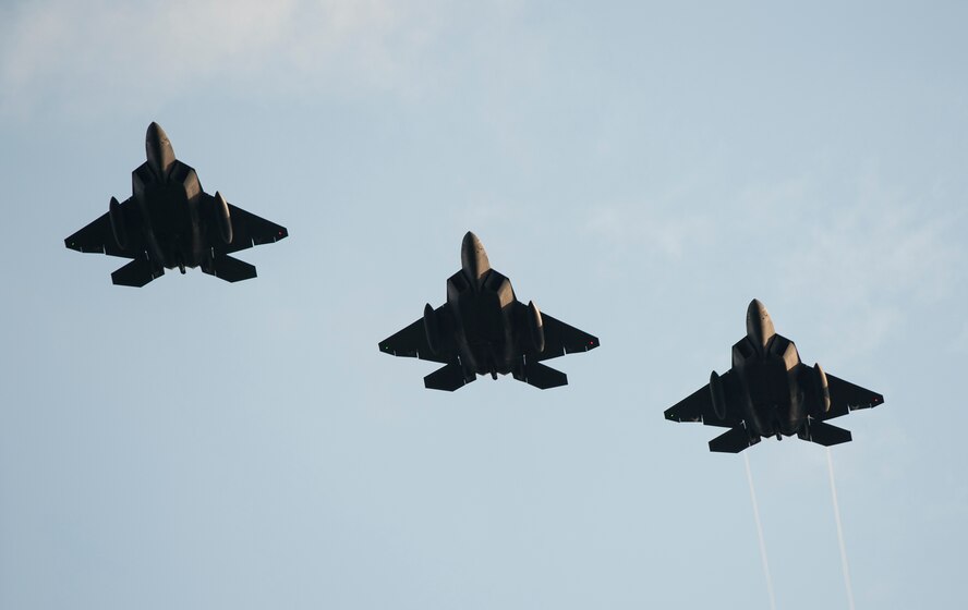 Three F-22 Raptor fighter aircraft fly over Spangdahlem Air Base, Germany, Aug. 28, 2015 as part of the inaugural F-22 training deployment to Europe. Four F-22s from the 95th Fighter Squadron at Tyndall Air Force Base, Fla., along with a C-17 Globemaster III cargo aircraft and more than 50 support Airmen were part of the deployment. This effort is part of the European Reassurance Initiative and will serve to assure allies of the Air Force’s commitment to European security and stability. (U.S. Air Force photo by Staff Sgt. Chad Warren/Released)