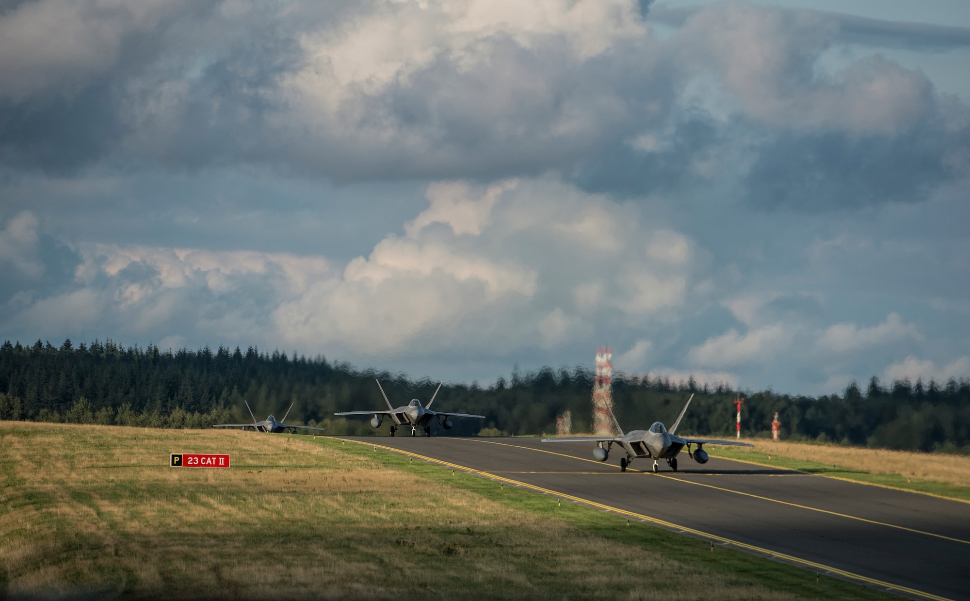 U.S. Air Force F-22 Raptor fighter aircraft pilots assigned to the 95th Fighter Squadron at Tyndall Air Force Base, Fla., taxi on the flightline Aug. 28, 2015, at Spangdahlem Air Base, Germany. The F-22s will conduct dissimilar air training with other Fighter Squadrons in U.S. Air Forces in Europe to include F-15 Eagle and F-16 Fighting Falcon fighter aircraft. The F-22 Raptors will also forward deploy for short periods of time to non-U.S. NATO bases. The USAF’s forward presence in Europe allows training with U.S. allies and partners to develop and improve regional security. (U.S. Air Force photo by Staff Sgt. Christopher Ruano/Released)