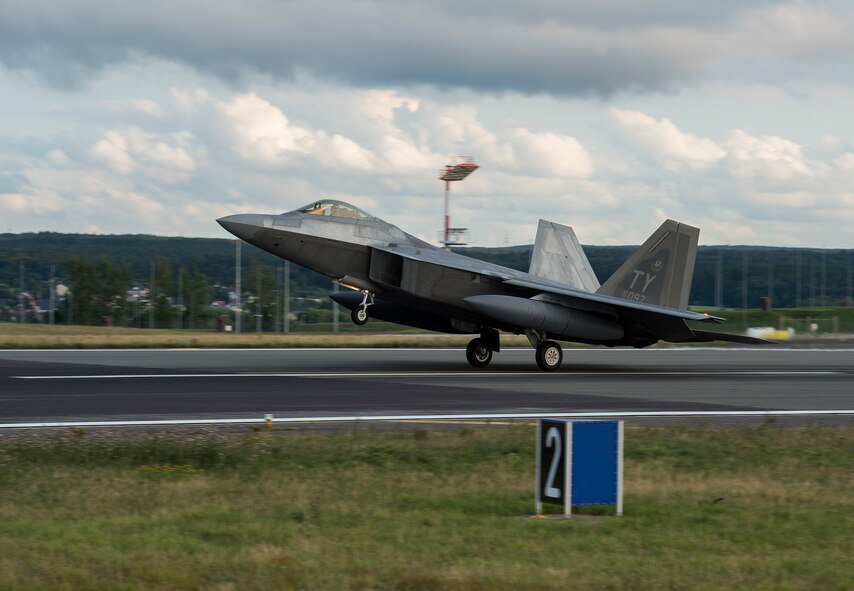 An F-22 Raptor fighter aircraft lands at Spangdahlem Air Base, Germany, Aug. 28, 2015 as part of the inaugural F-22 training deployment to Europe. The F-22s are deployed from the 95th Fighter Squadron at Tyndall Air Force Base, Fla., as part of the European Reassurance Initiative and will conduct air training with other Europe-based aircraft while demonstrating U.S. commitment to NATO allies and the security of Europe. (U.S. Air Force photo by Staff Sgt. Chad Warren/Released)