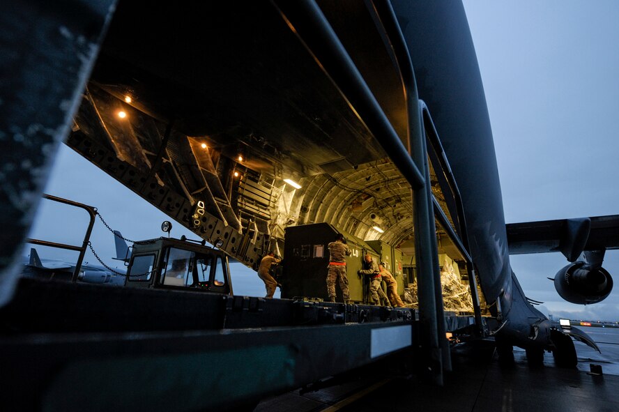 Airmen unload cargo from a U.S. Air Force C-17 Globemaster III from Charleston Air Force Base,  S.C., after arriving at Spangdahlem Air Base, Germany, to support the first ever F-22 Raptor European training deployment Aug. 28, 2015. A single C-17 can deliver nearly 85 tons of cargo to both prepared and unprepared airfields. (U.S. Air Force photo by Senior Airman Rusty Frank/Released)