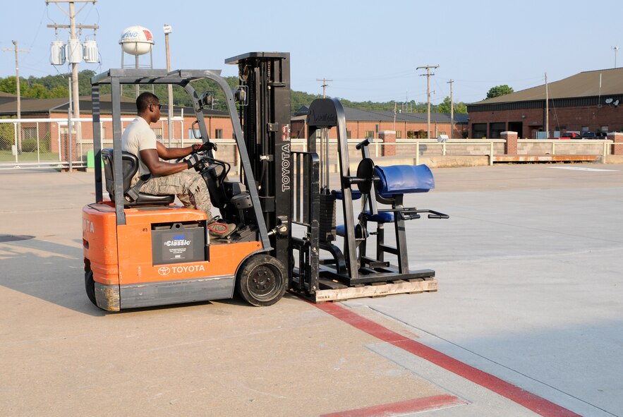 Staff Sgt. Richard Green loads gym equipment onto a truck, Aug. 26, 2015, at Ebbing Air National Guard Base, Ark. The equipment will be taken to Defense Reutilization and Marketing Office in Hooks, Texas. Green is assigned to the 188th Logistics Readiness Squadron. (U.S. Air National Guard photo by Staff Sgt. Hannah Dickerson/Released)