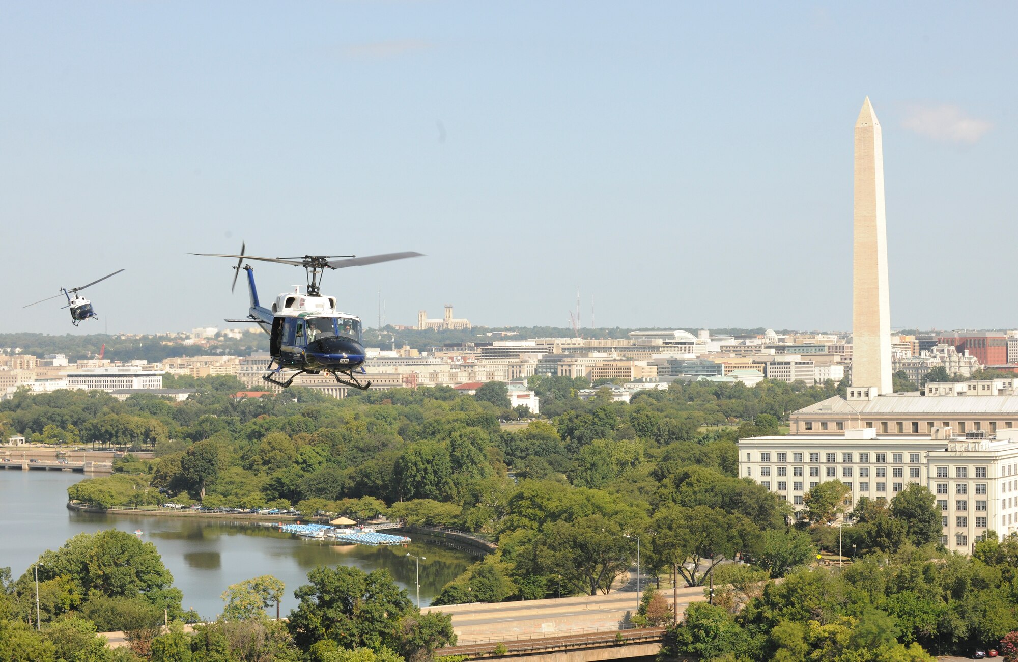 Two UH-1N Twin Hueys from the 1st Helicopter Squadron fly by the Washington Memorial, Washington D.C., Aug. 28, 2015. The helicopters flew for the Vietnam Helicopter Crew Members Association Memorial Service Flyover. (U.S. Air Force photo/ Airman 1st Class J.D. Maidens)