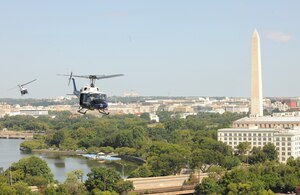 Two UH-1N Twin Hueys from the 1st Helicopter Squadron fly by the Washington Memorial, Washington D.C., Aug. 28, 2015. The helicopters flew for the Vietnam Helicopter Crew Members Association Memorial Service Flyover. (U.S. Air Force photo/ Airman 1st Class J.D. Maidens)