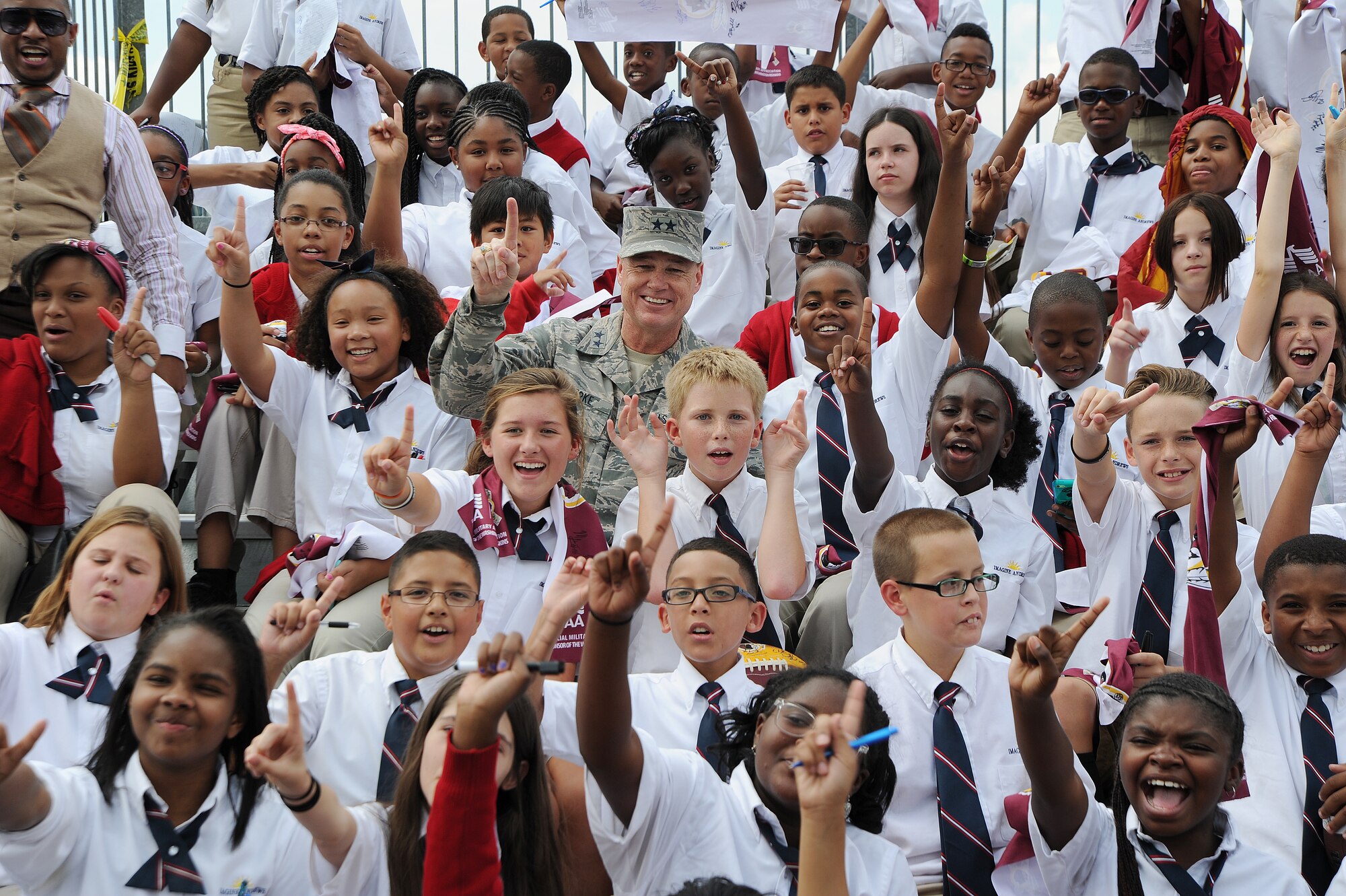 Air Force District of Washington Commander Maj. Gen. Darryl Burke takes a group with Imagine Andrews Public Charter School students as the Washington Redskins conduct a walkthrough practice at the fitness center's field, Joint Base Andrews, Md. on Aug. 28, 2015. The Redskins spent time meeting with Airmen, Sailors and Marines, family members and local school children and their chaperones to show their appreciation to the military community. The Redskins conducted the practice and signed autographs as part of their Redskins Salute effort. (U.S. Air Force photo/James E. Lotz)