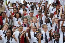 Air Force District of Washington Commander Maj. Gen. Darryl Burke takes a group with Imagine Andrews Public Charter School students as the Washington Redskins conduct a walkthrough practice at the fitness center's field, Joint Base Andrews, Md. on Aug. 28, 2015. The Redskins spent time meeting with Airmen, Sailors and Marines, family members and local school children and their chaperones to show their appreciation to the military community. The Redskins conducted the practice and signed autographs as part of their Redskins Salute effort. (U.S. Air Force photo/James E. Lotz)