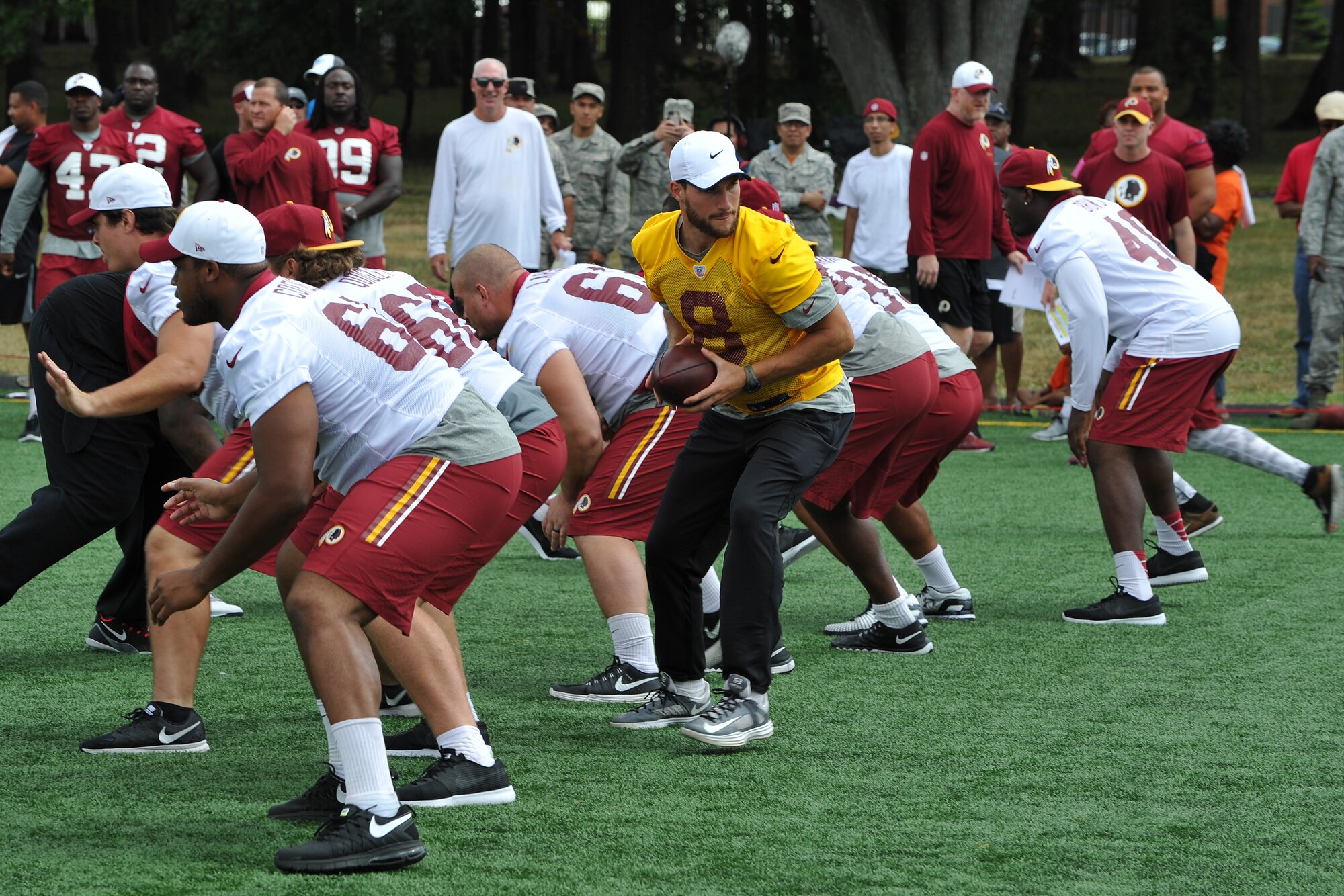 The Washington Redskins conduct a walkthrough practice at the fitness center's field, Joint Base Andrews, Md. on Aug. 28, 2015. The Redskins spent time meeting with Airmen, Sailors and Marines, family members and local school children and their chaperones to show their appreciation to the military community. The Redskins conducted the practice and signed autographs as part of their Redskins Salute effort. (U.S. Air Force photo/James E. Lotz) 