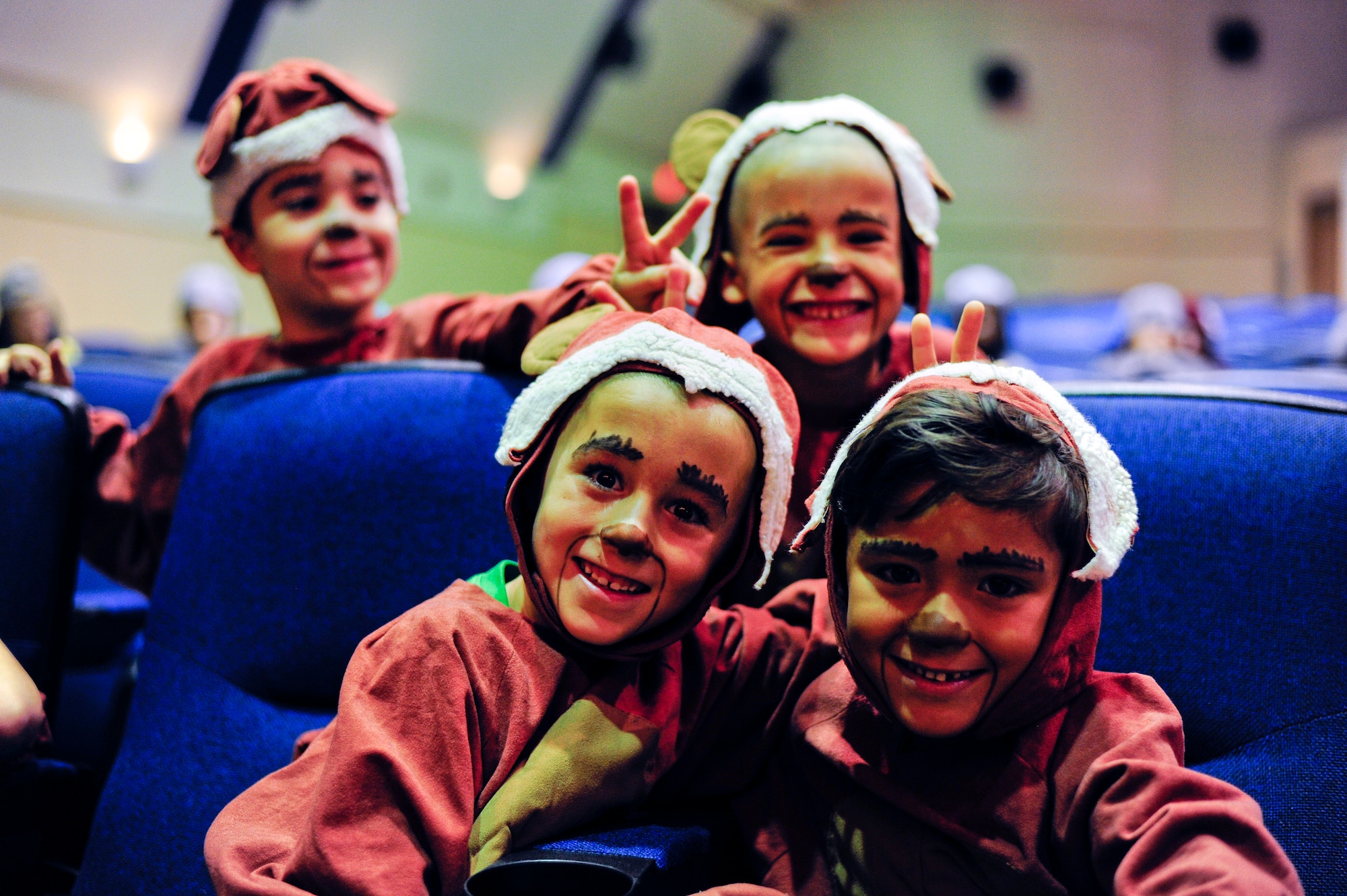 Children pose for a photo as they finish preparing for a play at MacDill Air Force Base, Fla., Aug. 21, 2015. Over 70 children auditioned for roles in the play, but only 60 were selected along with four children assistant directors.(U.S. Air Force photo by Airman 1st Class Mariette M. Adams/Released)