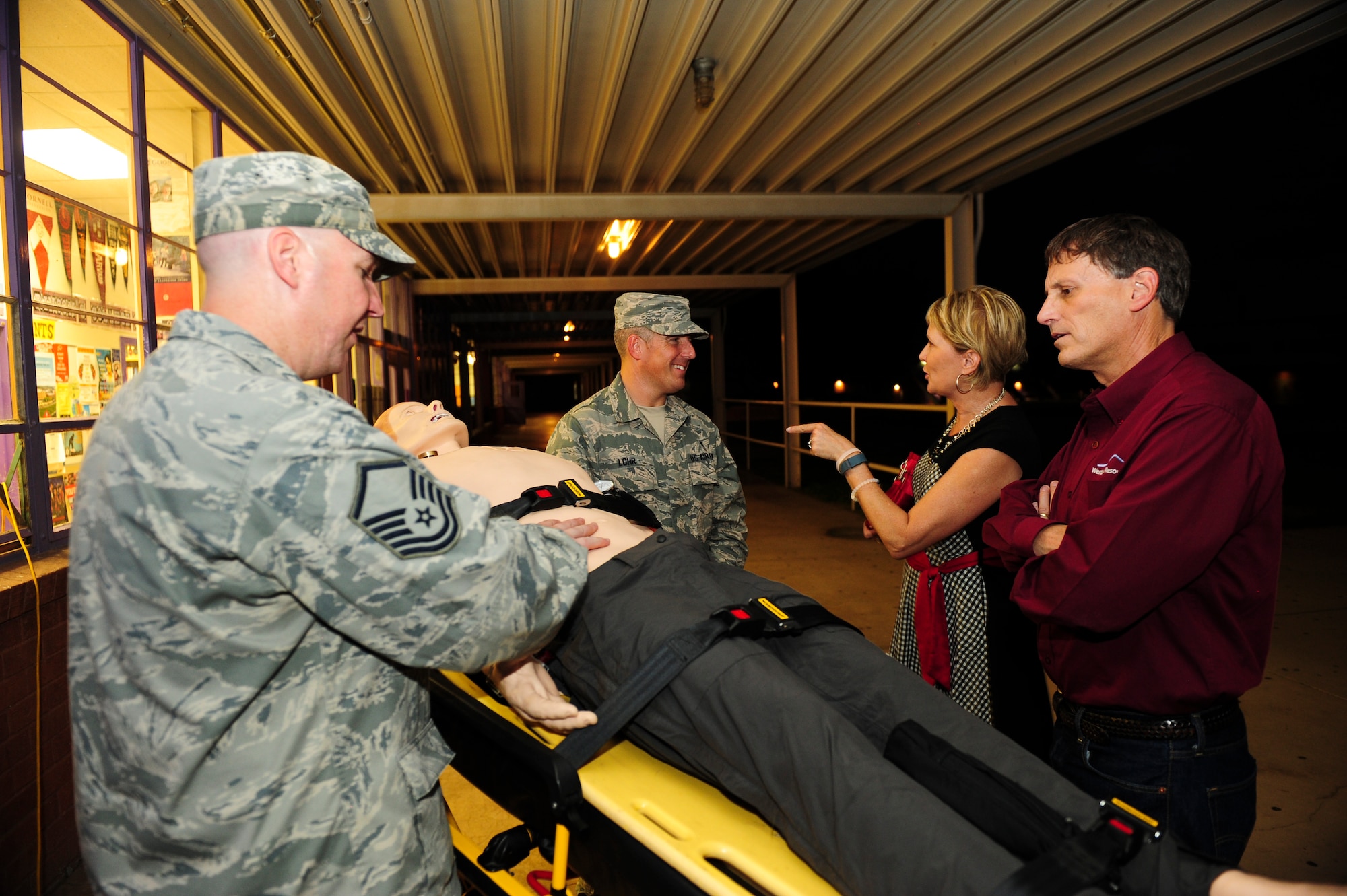 U.S. Air Force Airmen from the 355th Medical Group at Davis-Monthan Air Force Base answer questions about an advanced medical patient simulator during a Meet and Greet event at Rincon High School, Tucson, Ariz., Aug 26, 2015. The simulator is used by the medical group as a training platform that can display neurological and physiological symptoms. (U.S. Air Force photo by Airman 1st Class Chris Drzazgowski/Released)