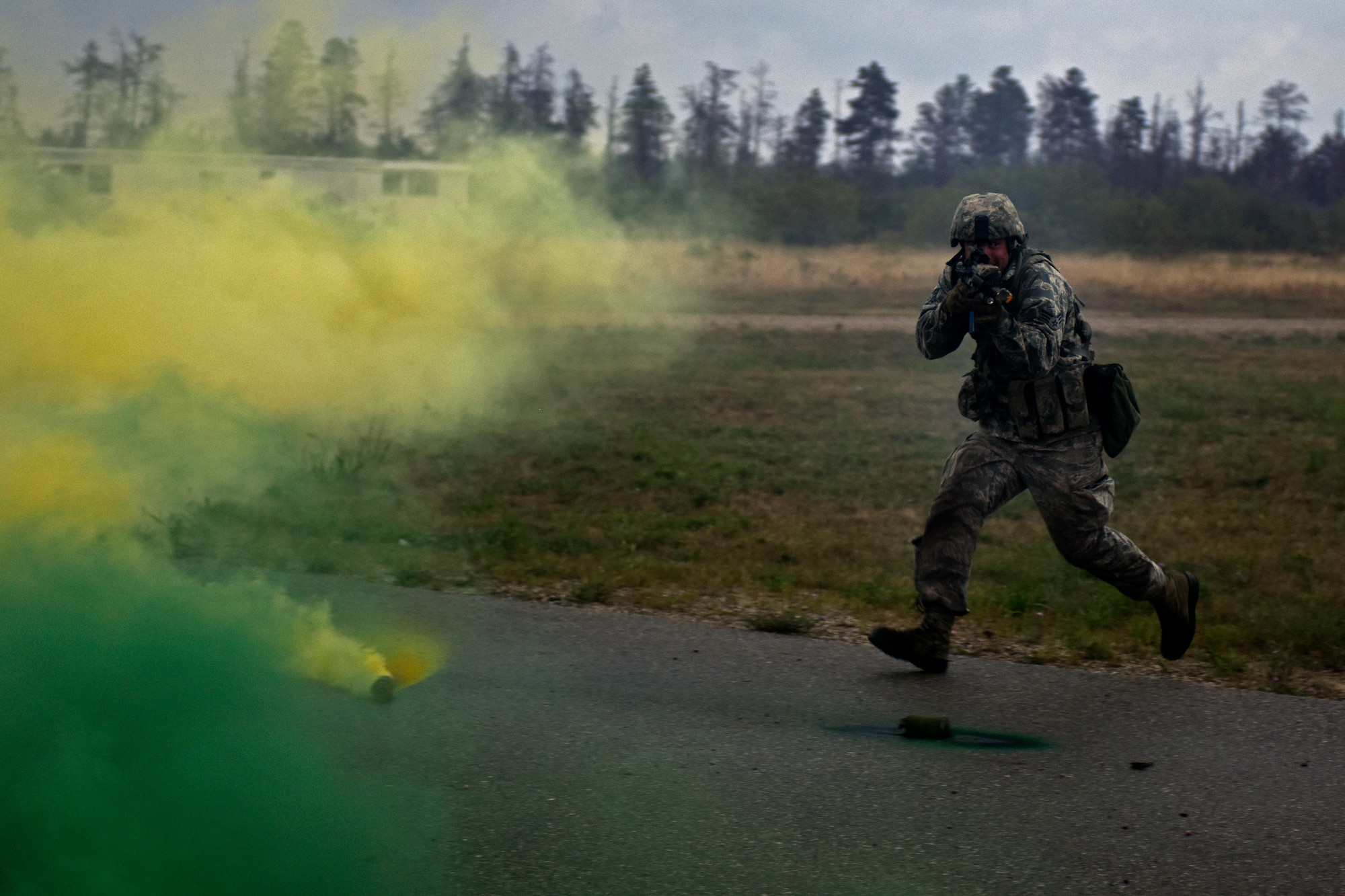 U.S. Air Force Senior Airman Nicholas Collins, with the 121st Security Forces Squadron, runs for cover during a training exercise Aug. 19, 2015 at Camp Grayling Joint Maneuver Training Center, Mich. Airmen with the 121st SFS spent three days in a simulated deployed environment at Camp Grayling as a part of their annual training. (U.S. Air National Guard photo by Airman Ashley Williams/Released)