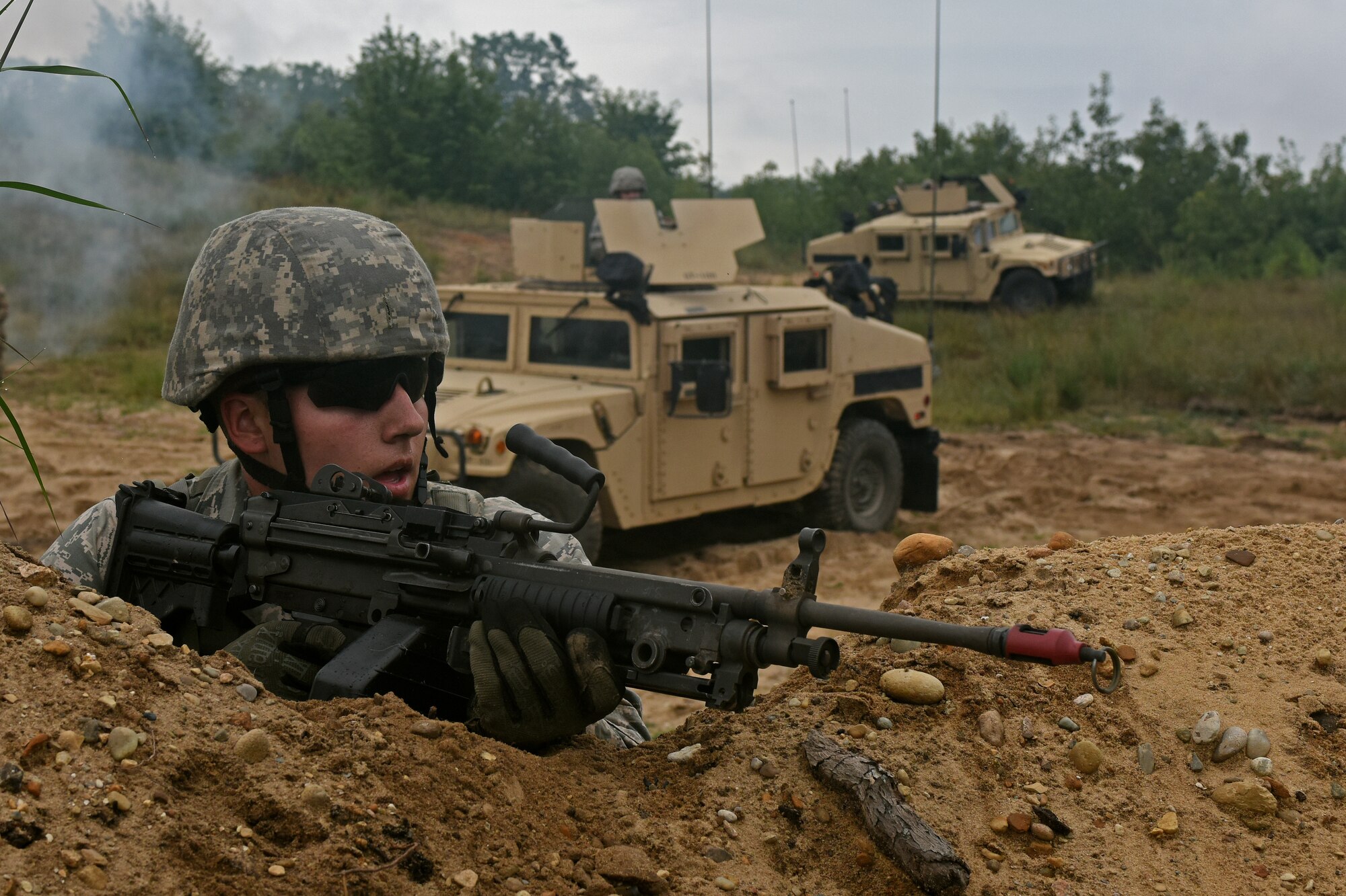 U.S. Air Force Senior Airman Sean White, with the 121st Security Forces Squadron, establishes security after receiving contact during a training exercise Aug. 18, 2015 at Camp Grayling Joint Maneuver Training Center, Mich. The 121st SFS Airmen spent three days at Camp Grayling in a simulated deployed environment as a part of their annual training. (U.S. Air National Guard photo by Airman Ashley Williams/Released)