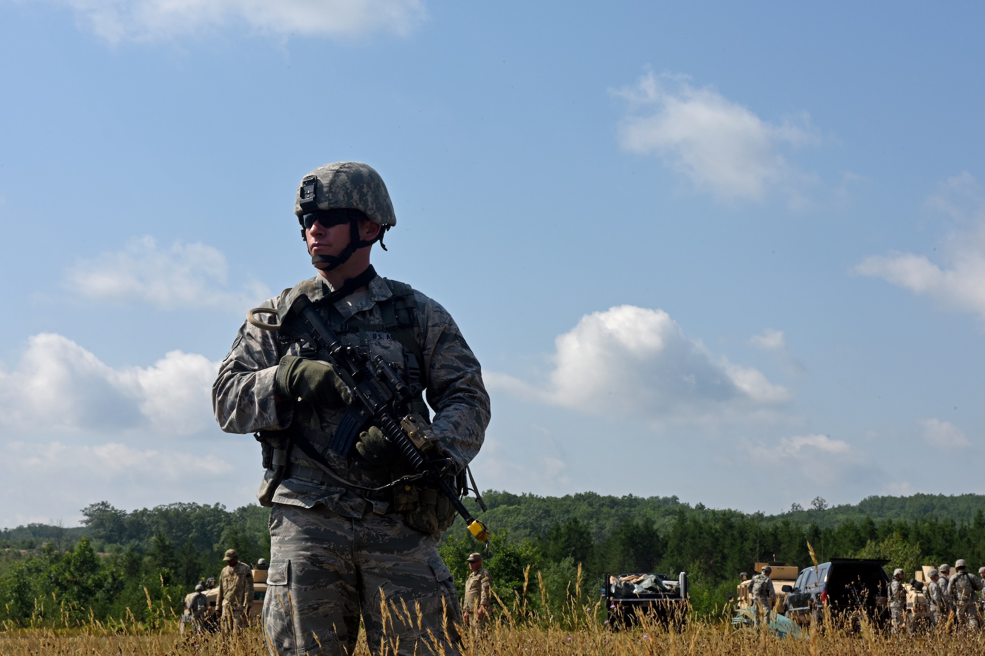 U.S. Air Force Senior Airman Cody Martin, with the 121st Security Forces Squadron, establishes security while 121st SFS Airmen set-up a Forward Operating Base during a training exercise Aug. 17, 2015 at Camp Grayling Joint Maneuver Training Center, Mich. The Airmen spent three days in a simulated deployed environment as a part of their annual training. (U.S. Air National Guard photo by Airman Ashley Williams/Released)