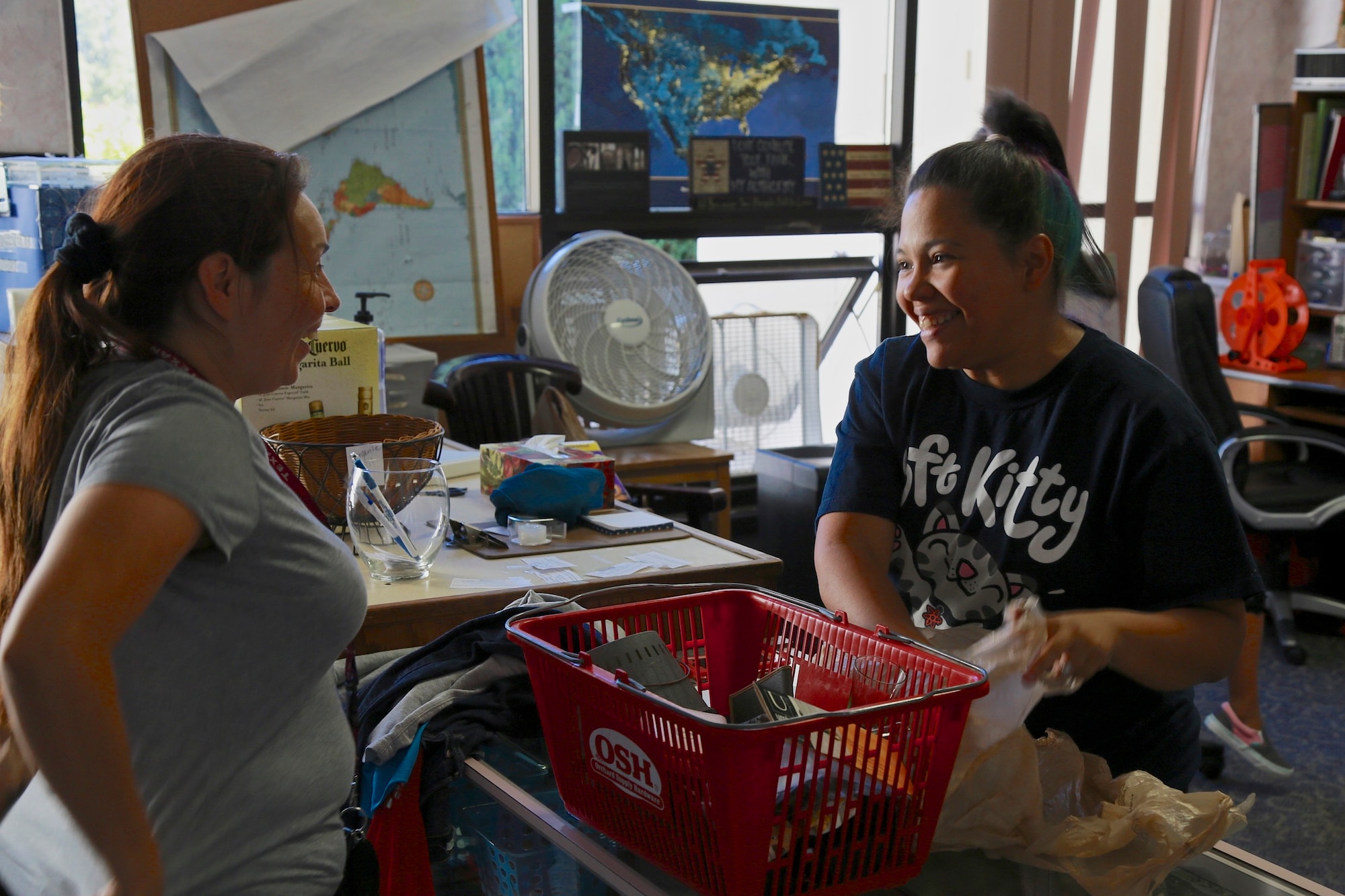 Nely Mendoza, Airmen's Attic volunteer, helps a patron check out with her new swag Aug. 23 at Travis Air Force Base, California. (U.S. Air Force photo by Maj. Samuel Lee)