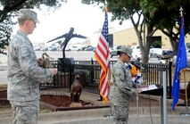 Senior Airman Todd Hagey a 433rd Aircraft Maintenance Squadron, integrated journeyman rings the bell for each crewmember, as Staff Sgt. Stefani Holt, 433rd AMXS aerospace maintenance craftsman, reads their names during the Bravo-12’s, 25th-anniversary ceremony Aug. 27, 2015, at Joint Base San Antonio-Lackland, Texas. The Bravo-12 mission began the morning of Aug. 29, 1990, in support of Operation Desert Shield, when engine trouble downed the C-5A Galaxy aircraft, killing nine 433rd Air Wing crew members and four duty passengers at Ramstein Air Base, Germany. (U.S. Air Force photo by Benjamin Faske) (released)
