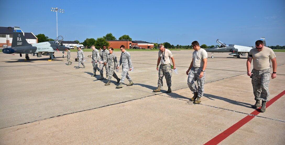Active duty and 932nd Airlift Wing reservists work side by side on the flightline to clean up debris that could cause possible damage to aircraft engine intakes, Aug. 18, 2015, Scott Air Force Base, Illinois. (U.S. Air Force photo / Christopher Parr)