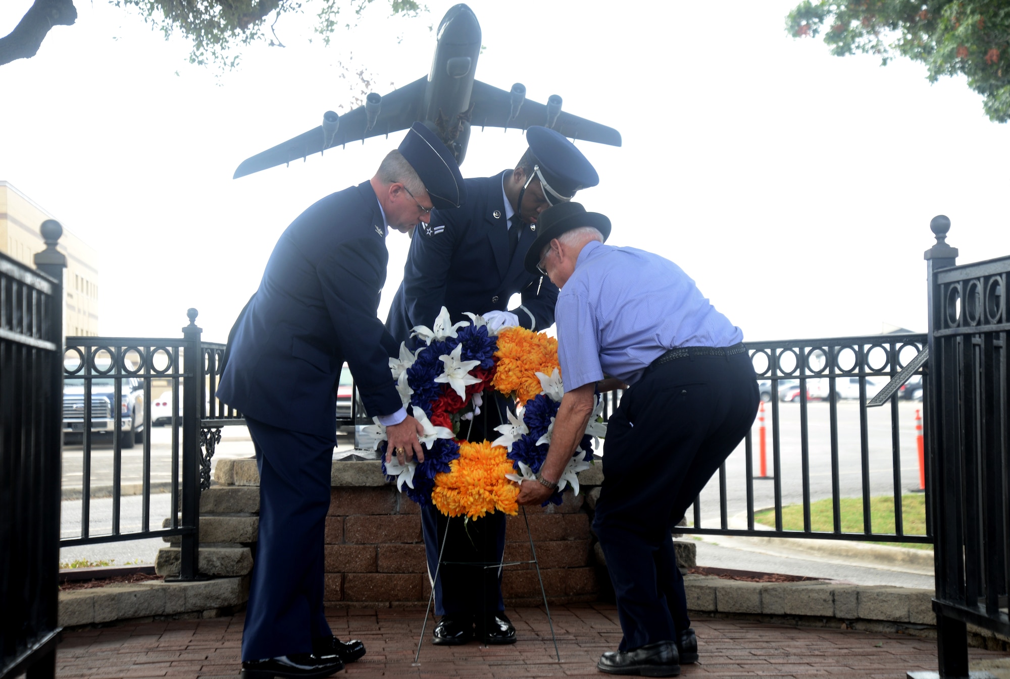 Col. David A. Scott, 433rd Airlift Wing vice commander and retired Col. Rich Ferguson, place a wreath at the BRAVO-12 Memorial Aug. 27, 2015, at Joint Base San Antonio-Lackland, Texas. This year marks the 25th Anniversary of the Bravo-12 mission where nine 433rd AW crewmembers and four duty passengers paid the ultimate price when their C-5A Galaxy crashed on the outskirts of Ramstein Air Base, Germany in support of Operation Desert Shield.  (U.S. Air Force photo by Benjamin Faske) (released)