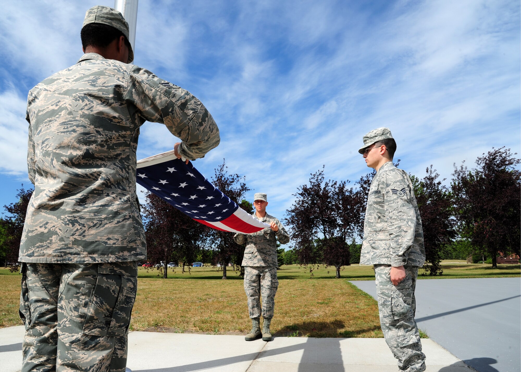 Airmen from the 319th Air Base Wing practice folding the flag August 19, 2015, on Grand Forks Air Force Base, North Dakota. The Airmen were a part of the flag detail that performed a formal retreat ceremony August 21, 2015. (U.S. Air Force photo by Airman 1st Class Ryan Sparks/Released)
