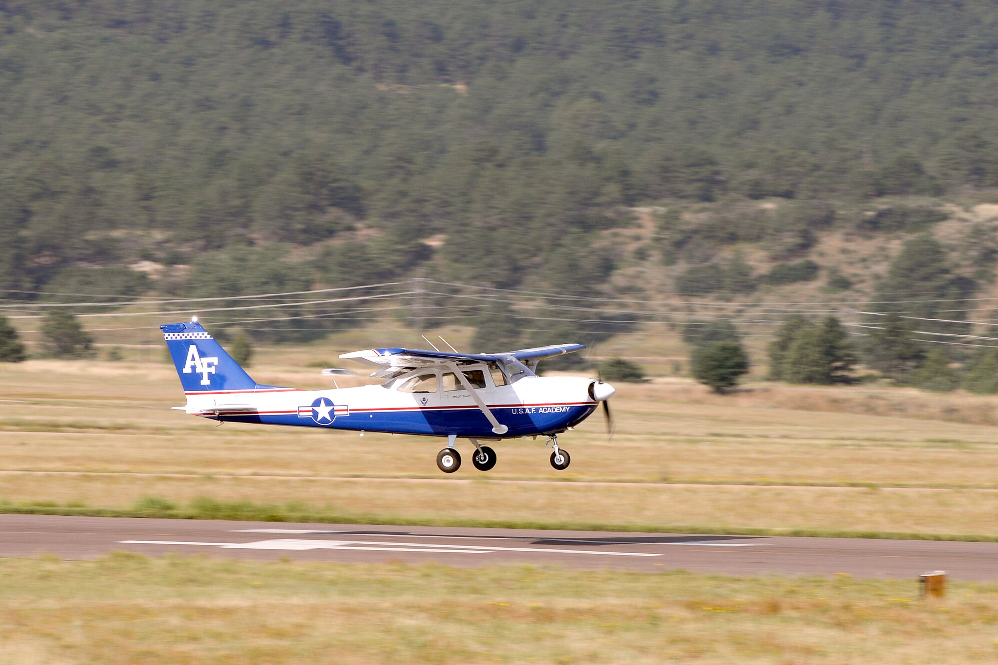 A T-41 takes off at the U.S. Air Force Academy airfield August 25, 2015. Original Tuskegee Airman Franklin Macon was riding inside in what was possibly his last ride. Macon took his first powered flight at the airfield when it was only a dirt strip. (U.S. Air Force photo/Mike Kaplan)