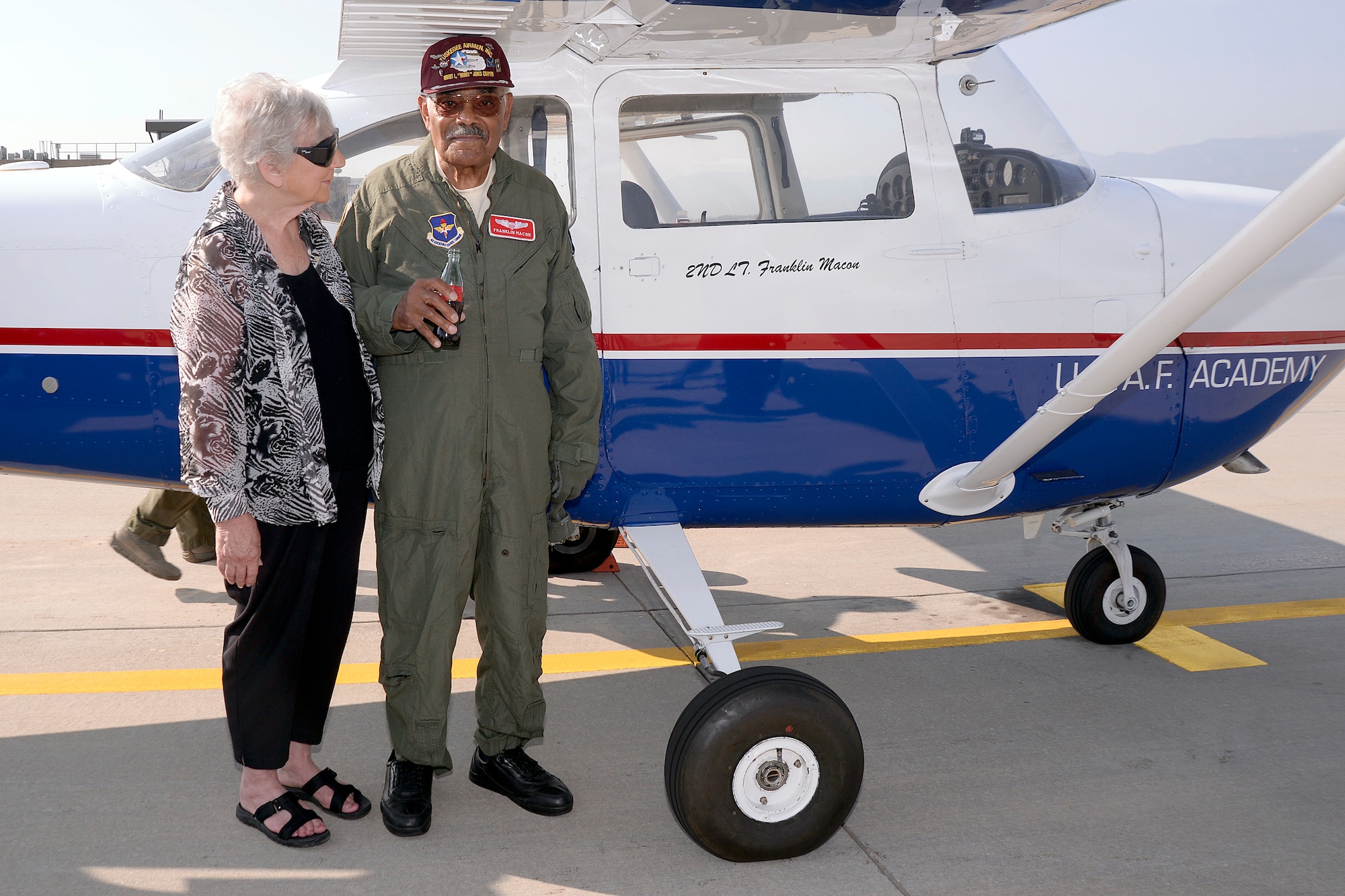 Original Tuskegee Airman Franklin Macon stands with his girlfriend, Amy Lee, on the U.S. Air Force Academy airfield August 25, 2015. Macon had just taken a flight with a cadet in Cadet 1st Class Scott Lafferty in one of the cadet flying team’s T-41s.  (U.S. Air Force photo illustration/Mike Kaplan)