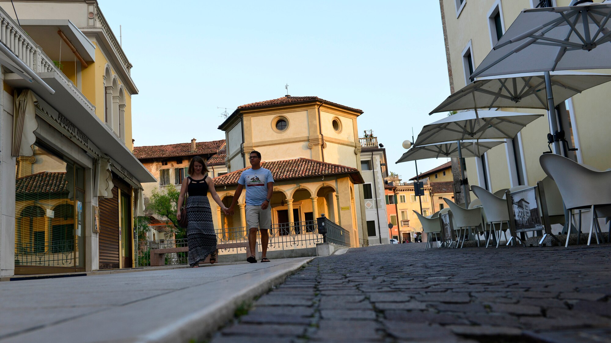 U.S. Air Force Airman Matthew Medina, 31st Aircraft Maintenance Squadron weapons load member, and his wife, Alexis, walk by shops and restaurants, Aug. 28, 2015, in Sacile, Italy. The Medinas frequently visit Sacile and Lignano to enjoy the local Italian culture. (U.S. Air Force photo by Airman 1st Class Cary Smith/Released)