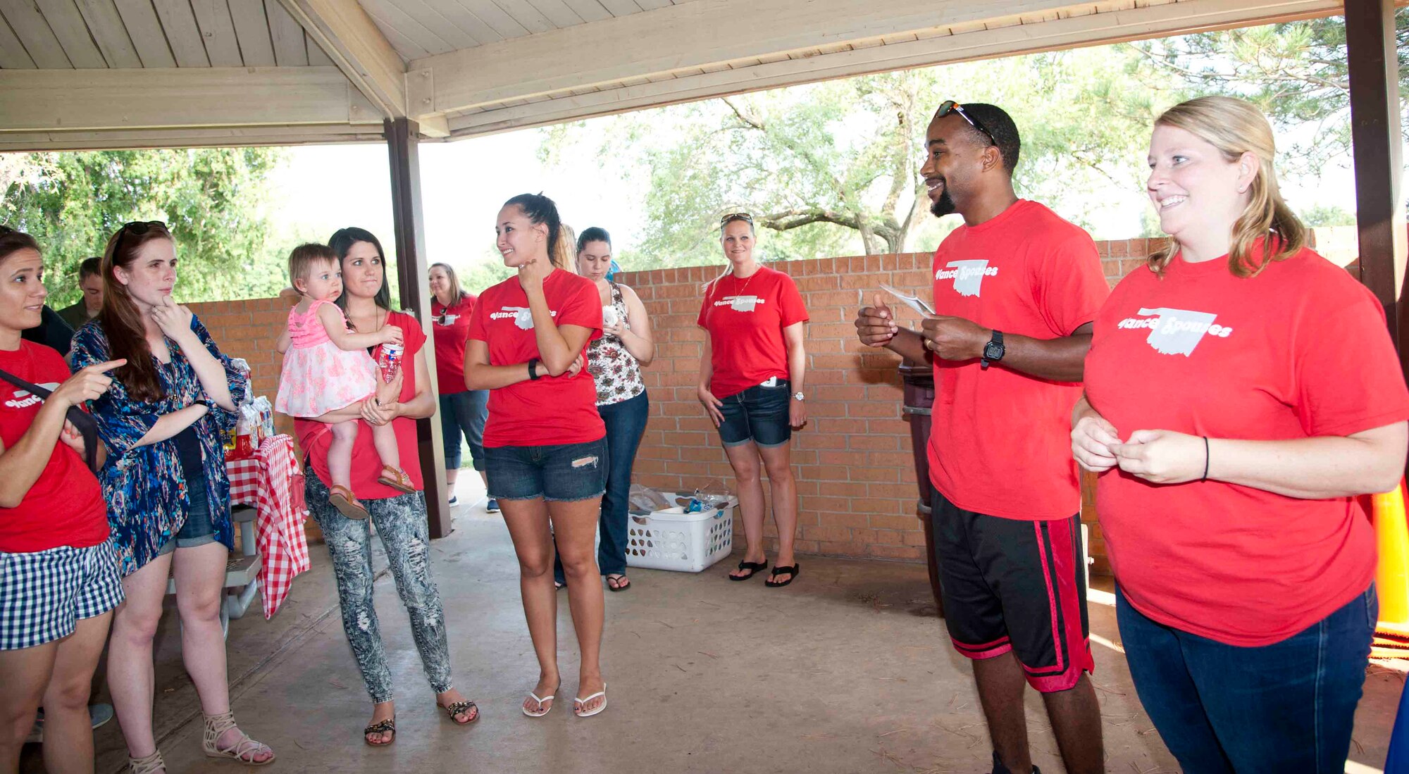 Meg Hewes (right), the president of the Officers’ Spouses’ Club, and Jeremy Burden, the president of the Enlisted Spouses’ Group, speak to a group during an ice cream social and membership drive Aug. 25 at the Base Park. The two spouses groups will merge into one group in September and become the Vance Spouses’ Club. (U.S. Air Force photo / Staff Sgt. Nancy Falcon)