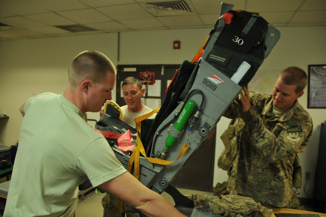 Members of the 187th Maintenance Group Egress Shop inspect an ACES II ejection seat for before it can be installed into F-16 Fighting Falcon, July 26, 2014, Bagram Air Field, Afghanistan. The Maintenance Group maintained the highest mission capable rates in Bagram's recent history. (U.S. Air Force photo by Tech. Sgt. Matthew Garrett\Released)