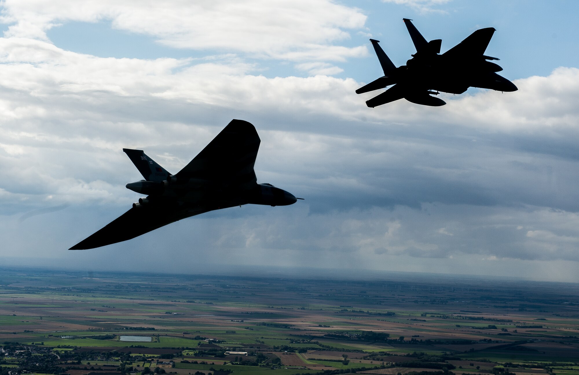 The Avro Vulcan XH558, accompanied by an F-15C Eagle assigned to the 48th Fighter Wing, flyover Royal Air Force Lakenheath, England, Aug. 27, 2015 during a fly over event. This historic event marks the first and last time these aircraft will ever fly together. This particular Vulcan was the first one to be delivered to the RAF and now the last complete Vulcan in the world. (U.S. Air Force photo/Senior Airman Trevor T. McBride/Released)