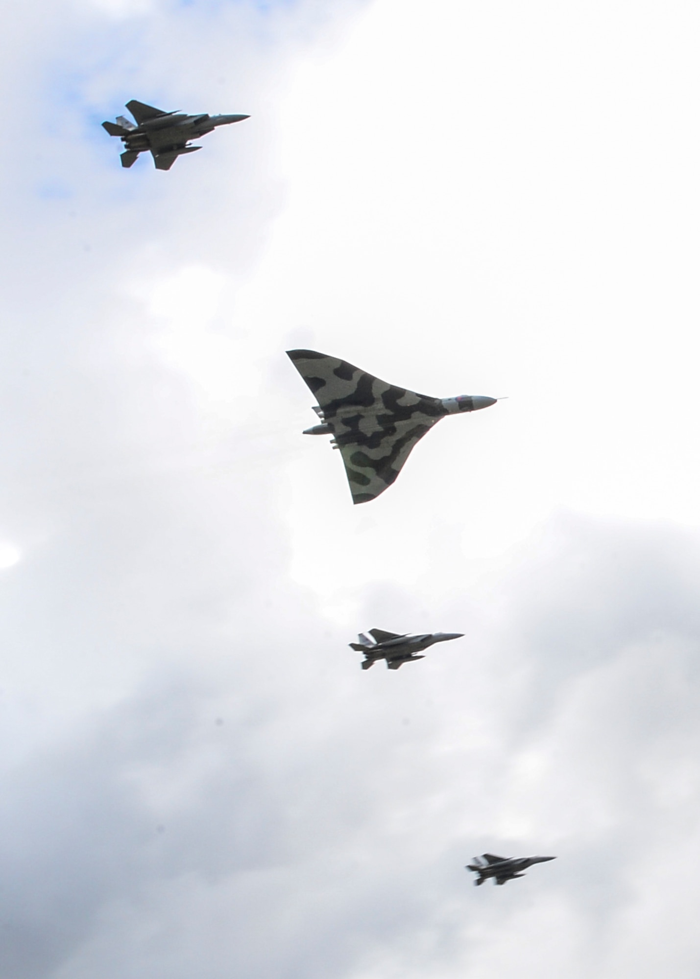 The Vulcan XH558 flies in unison with a pair F-15C Eagles over RAF Lakenheath, England, Aug. 27, 2015. Scheduled to retire in September, the Avro Vulcan XH558 contains history and notoriety throughout the United Kingdom since its first flight in 1960 through display flights and its participation in the Cold War. (U.S. Air Force photo by Senior Airman Nigel Sandridge/Released)