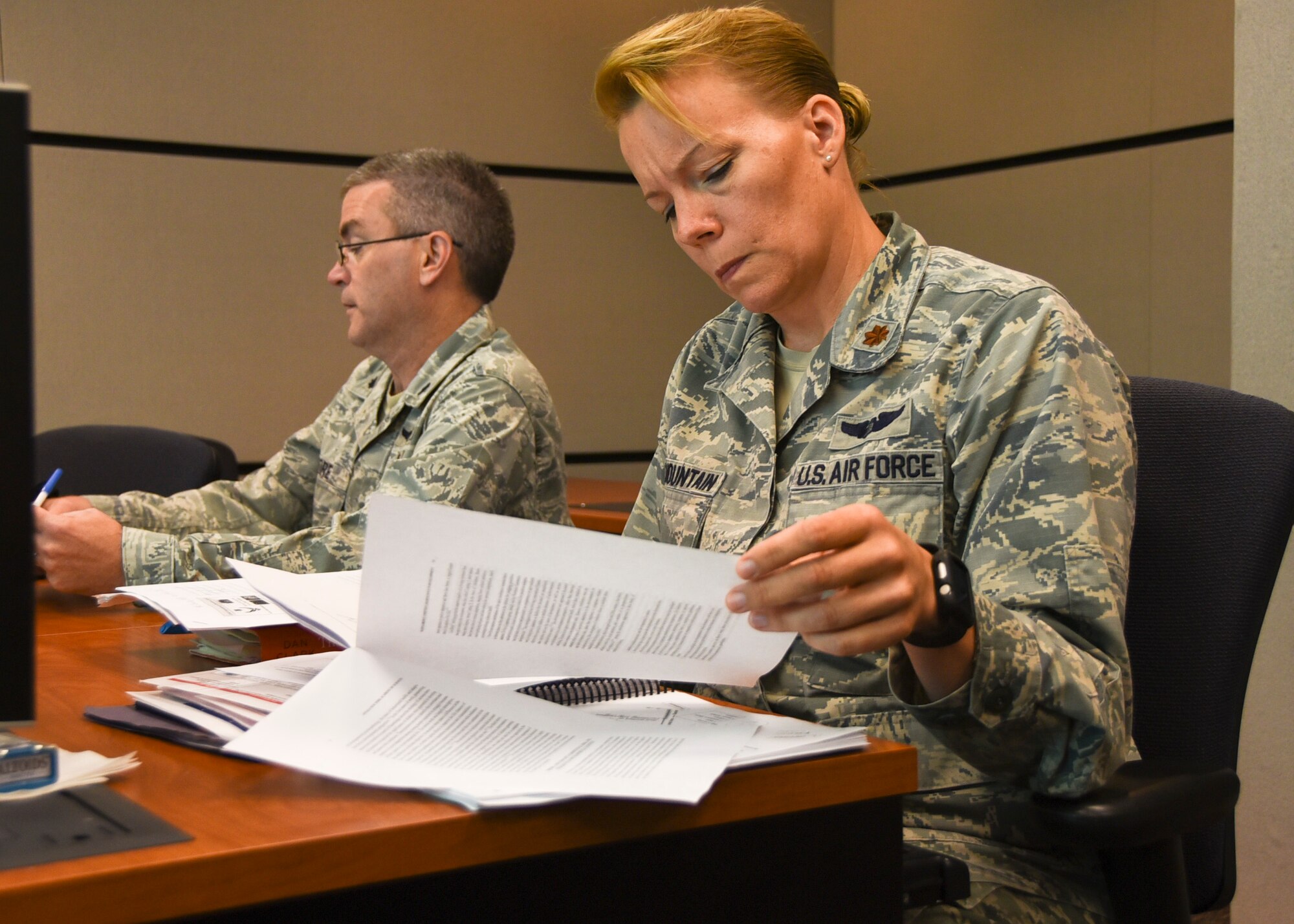 Lt. Col. Thomas Moore, Air Force Medical Support Agency chief of health promotions, and Maj. Marella Big Mountain, from the Profession of Arms Center of Excellence, review Master Resilience Trainer Course information at the U.S. Air Force Expeditionary Center, Aug. 13. The MRTC, taught at the USAFEC, underwent an Instructional System Design review with credentialed Airmen whose professions align with the Comprehensive Airmen Fitness model of Mental, Physical, Social, and Spiritual domains. (U.S. Air Force photo/Bradley Camara)