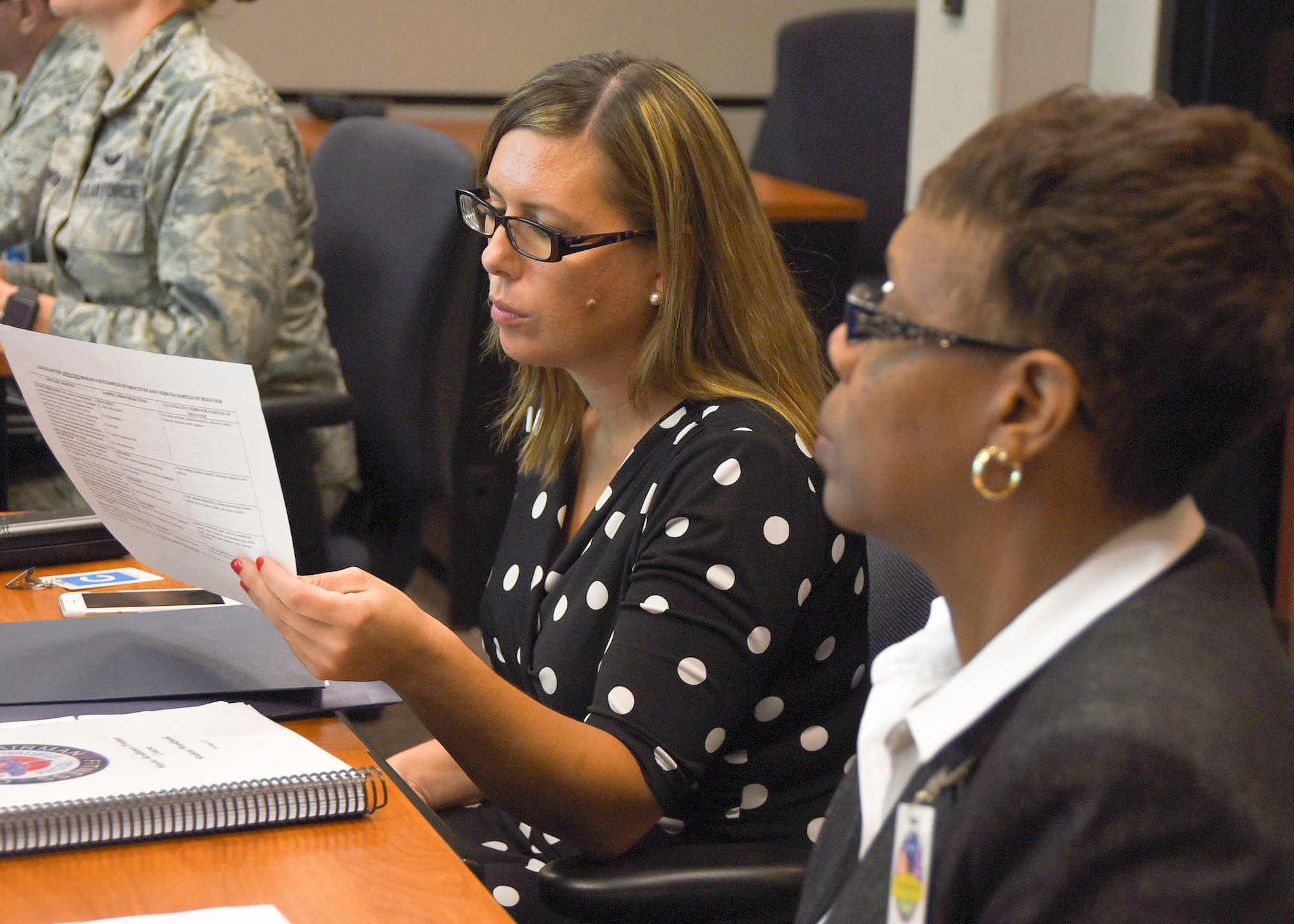Jenna Lightfoot, 99th Air Base Wing community support coordinator, and Dr. Jacqueline Shiflet, Air Force Personnel Center chief of resilience operations, review Master Resilience Trainer Course information at the U.S. Air Force Expeditionary Center, Aug. 13. The MRTC, taught at the USAFEC, underwent an Instructional System Design review with credentialed Airmen whose professions align with the Comprehensive Airmen Fitness model of Mental, Physical, Social, and Spiritual domains. (U.S. Air Force photo/Bradley Camara)