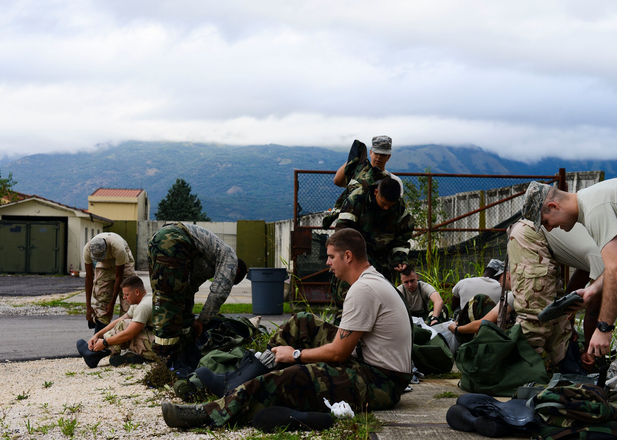 Airmen from the 31st Civil Engineer Squadron dawn protective gear during a monthly prime base engineer emergency force, or Prime BEEF, training exercise, Aug. 25, 2015, at Aviano Air Base, Italy. Training participants had to complete a vehicle familiarization course in Mission Oriented Protective Posture level four (MOPP 4) as part of the exercise. (U.S. Air Force photo by Senior Airman Austin Harvill/Released)