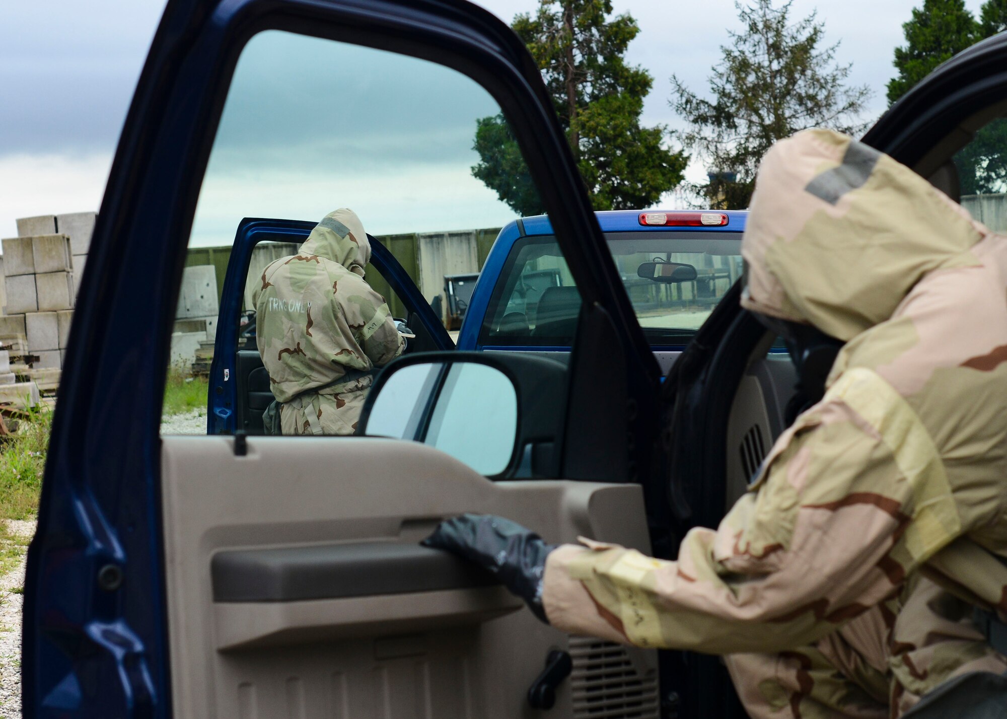 Airmen from the 31st Civil Engineer Squadron enter trucks during a monthly prime base engineer emergency force, or Prime BEEF, training exercise, Aug. 25, 2015, at Aviano Air Base, Italy. Training participants prepared for a vehicle familiarization course in Mission Oriented Protective Posture level four (MOPP 4). (U.S. Air Force photo by Senior Airman Austin Harvill/Released)