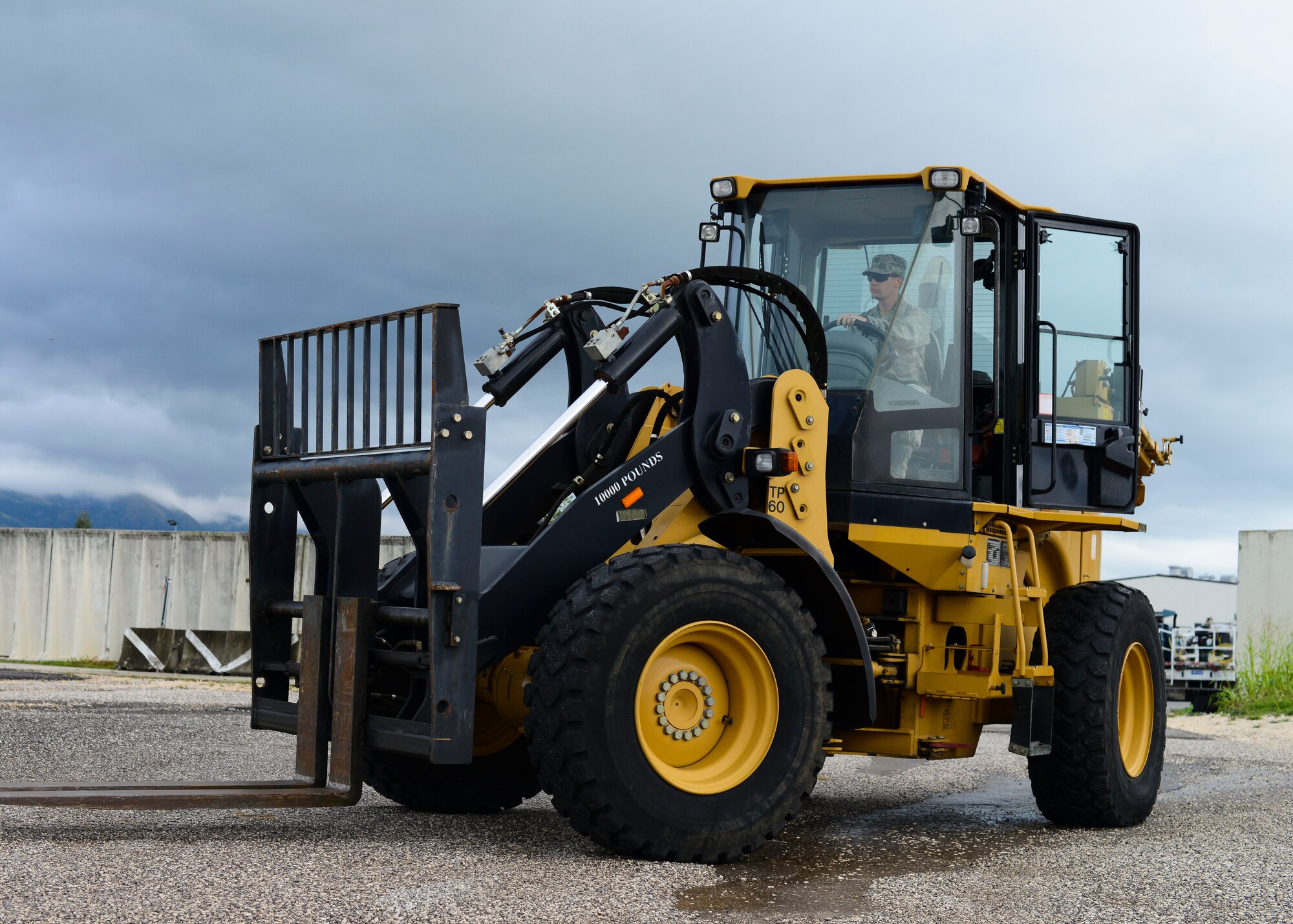 U.S. Air Force Maj. Scott Wallace, 31st Civil Engineer Squadron operations flight commander, operates a 10k all-terrain forklift during a monthly prime base engineer emergency force, or Prime BEEF, training exercise, Aug. 25, 2015, at Aviano Air Base, Italy. In addition to driving, participants had to lift weighted pallets onto a truck bed to accomplish the training. (U.S. Air Force photo by Senior Airman Austin Harvill/Released)