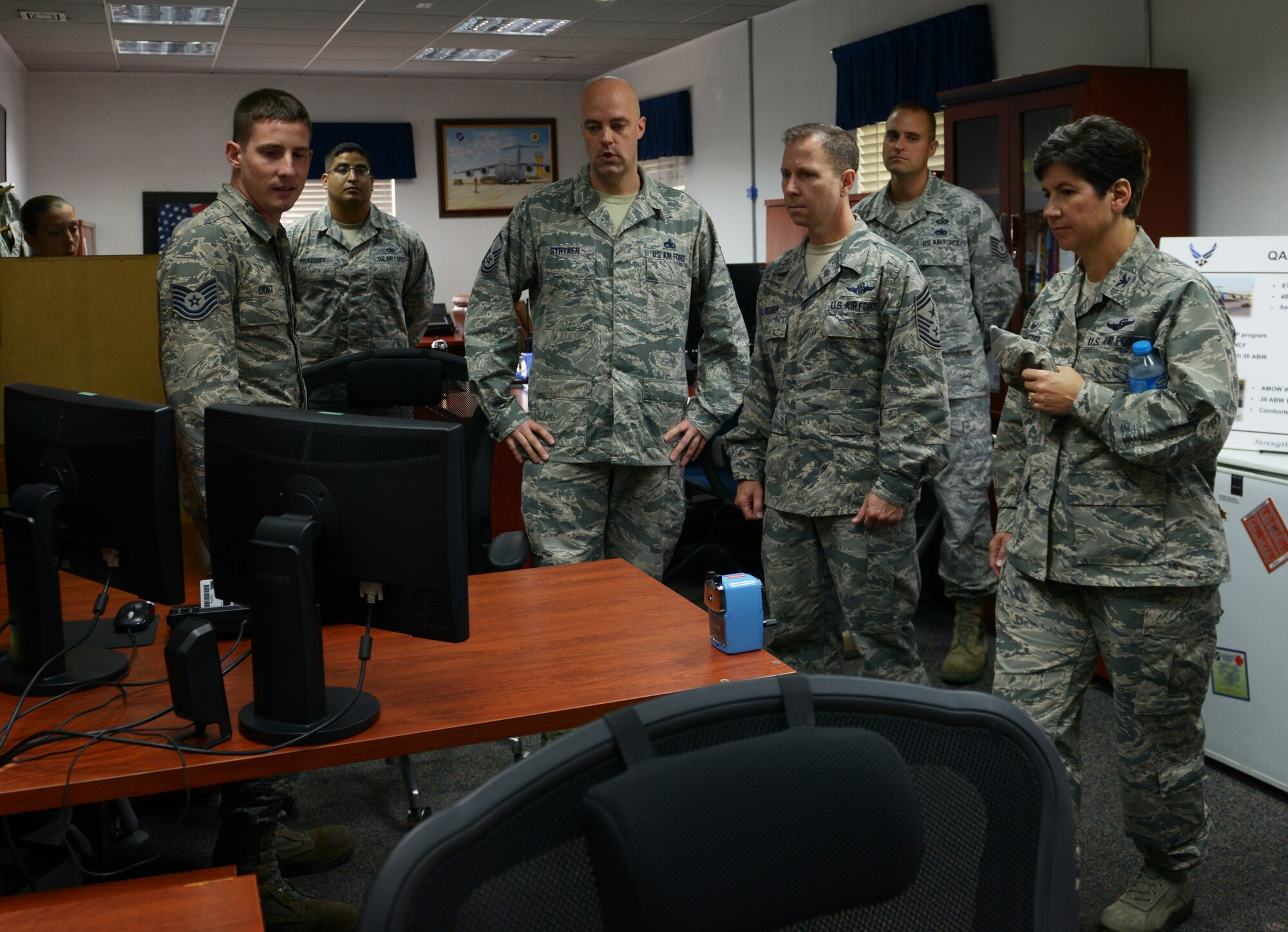 Col. Nancy Bozzer, 521st Air Mobility Operations Wing commander, and Chief Master Sgt. Mark Redden, 521st AMOW command chief, speak with Airmen from the quality assurance, safety and air transportation standardization evaluation section of the 728th Air Mobility Squadron Aug. 24, 2015, at Incirlik Air Base, Turkey. The Airmen spoke with Bozzer and Redden about improvements and innovations their section is working on. (U.S. Air Force photo by Senior Airman Krystal Ardrey/Released)