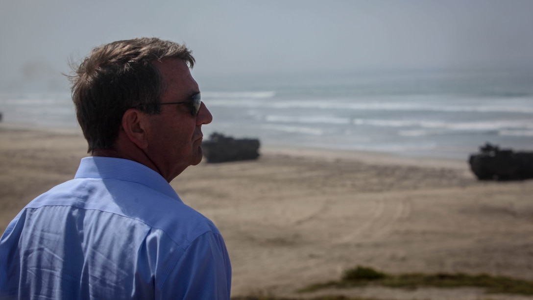 The U.S. Secretary of Defense, the honorable Mr. Ashton Carter, observes reconnaissance Marines and Amphibious Assault Vehicles secure a beach head during his visit to Marine Corps Base Camp Pendleton, Calif., Aug. 27, 2015. Carter met with senior military leaders and service members and witnessed ship-to-shore operations, a capability synonymous with Navy and Marine Corps teams in order to assess the need to better support military capabilities.