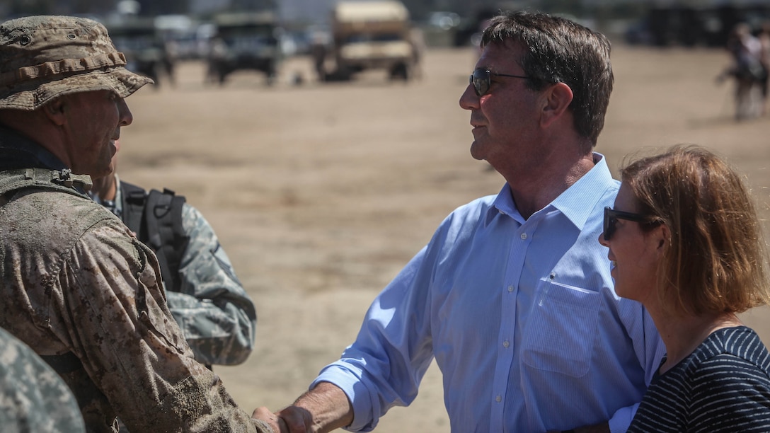 The U.S. Secretary of Defense, the honorable Mr. Ashton Carter congratulates a young reconnaissance Marine on a job well done following a combined arms raid aboard Marine Corps Base Camp Pendleton, Calif., Aug. 27, 2015. Carter met with senior military leaders and service members and witnessed ship-to-shore operations, a capability synonymous with Navy and Marine Corps teams in order to assess the need to better support military capabilities.
