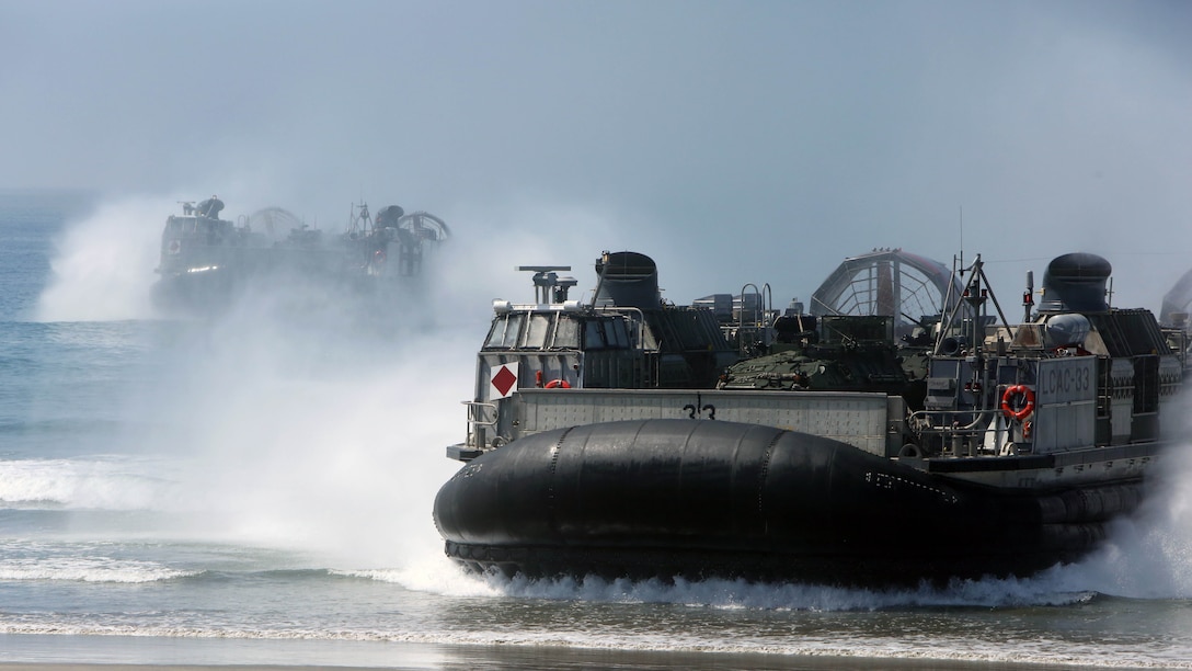 Marines and light armored vehicles with 3rd Light Armored Reconnaissance Battalion, 1st Marine Division, are transported to shore by Landing Craft Air Cushions (LCACs) from the Navy’s Assault Craft Unit 5, during an amphibious raid demonstration in conjunction with a visit from the secretary of defense, aboard Marine Corps Base Camp Pendleton, Calif., Aug. 27, 2015. The LCACs transported the LAVs and Marines to the objective area while Marines from Company A, 1st Battalion, 1st Marine Regiment, used amphibious assault vehicles with 3rd Assault Amphibian Battalion to conduct the raid demonstration.