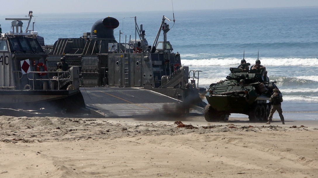 Marines with 3rd Light Armored Reconnaissance Battalion, 1st Marine Division, maneuver their light armored vehicles off Landing Craft Air Cushions (LCACs) from the Navy’s Assault Craft Unit 5, during an amphibious raid demonstration in conjunction with a visit from the secretary of defense, aboard Marine Corps Base Camp Pendleton, Calif., Aug. 27, 2015. The LCACs transported the LAVs and Marines from the USS New Orleans (LDP 18) while Marines from Company A, 1st Battalion, 1st Marine Regiment, 1st Mar. Div. used amphibious assault vehicles with 3rd Assault Amphibian Battalion, 1st Mar. Div. to assault their objective. 