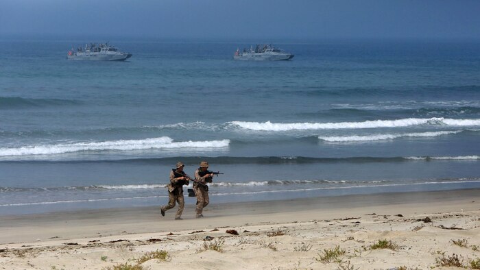 Marines with 1st Reconnaissance Battalion, 1st Marine Division, maneuver up the beach during an amphibious raid demonstration in conjunction with a visit from the secretary of defense, aboard Marine Corps Base Camp Pendleton, Calif., Aug. 27, 2015.   The Marines inserted close to the beach using riverine command boats and swam ashore to conduct a beach reconnaissance with the mission to identify obstacles or enemy that may interfere with the main amphibious landing. 