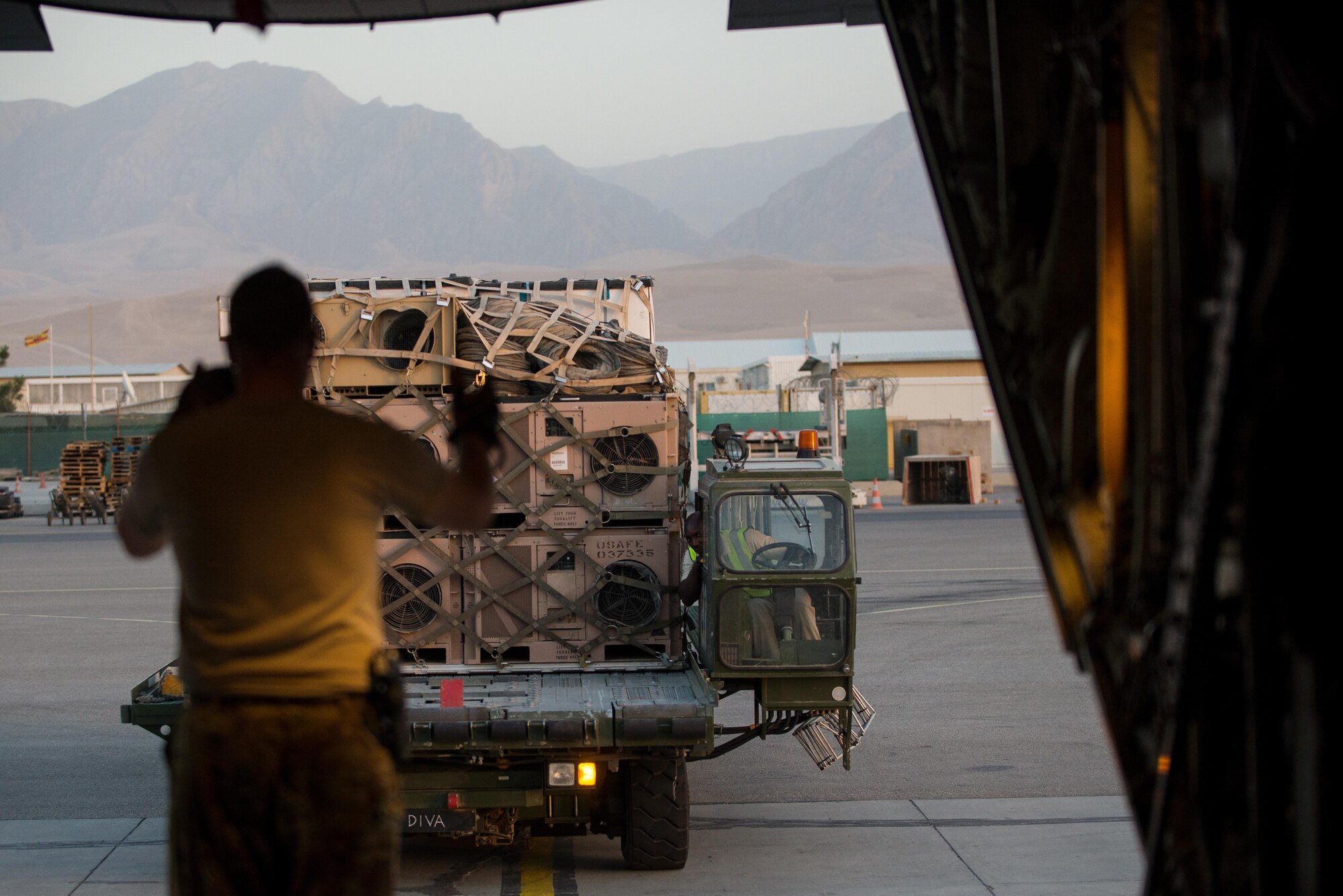 A U.S. Airman assigned to the 774th Expeditionary Airlift Squadron directs a K loader while loading cargo onto an Air Force C-130J Super Hercules aircraft at Mazar-e Sharif Airfield, Afghanistan, Aug 27, 2015. The aircrafts short takeoff and landing capability makes it an optimum fit for Afghanistan’s rugged terrain. (U.S. Air Force photo by Tech. Sgt. Joseph Swafford/Released)