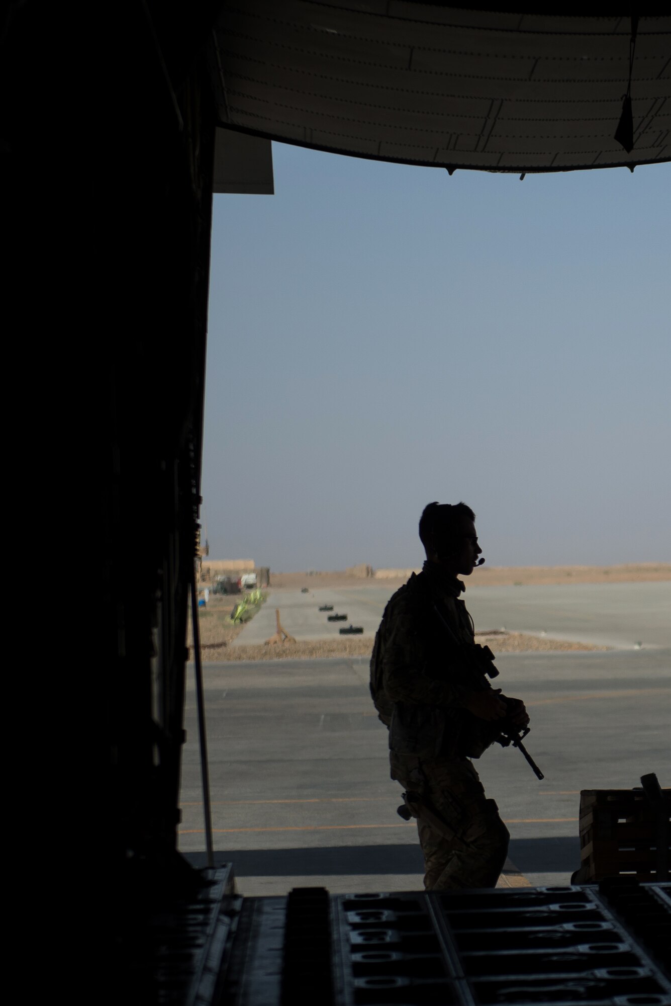 A U.S. Airman assigned to the 445th Expeditionary Security Forces Squadron provides security as cargo is unloaded from an Air Force C-130J Super Hercules aircraft at Camp Dwyer, Afghanistan, Aug. 27, 2015. The aircrafts short takeoff and landing capability makes it an optimum fit for Afghanistan’s rugged terrain. (U.S. Air Force photo by Tech. Sgt. Joseph Swafford/Released)