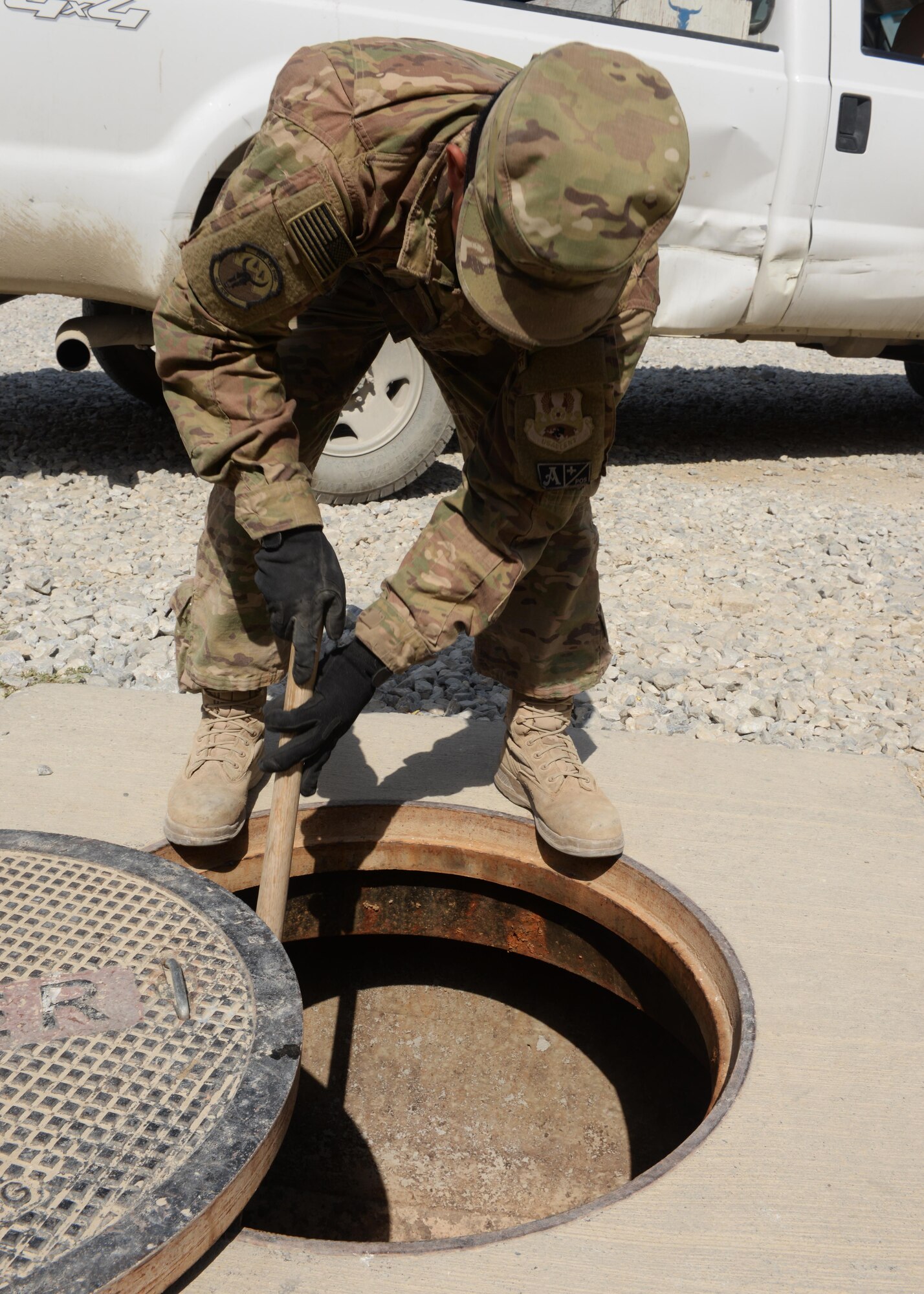 U.S. Air Force Reigel Daylo, 455th Expeditionary Civil Engineer Squadron water and fuel systems maintenance journeyman, checks a water system for debris Aug. 27, 2015, at Bagram Airfield, Afghanistan. Daylo is one of three Airmen responsible for maintaining the fuel line on the airfield as well as quality of life of some living quarters on base and a few facilities that are not yet contracted. (U.S. Air Force photo by Senior Airman Cierra Presentado/Released)