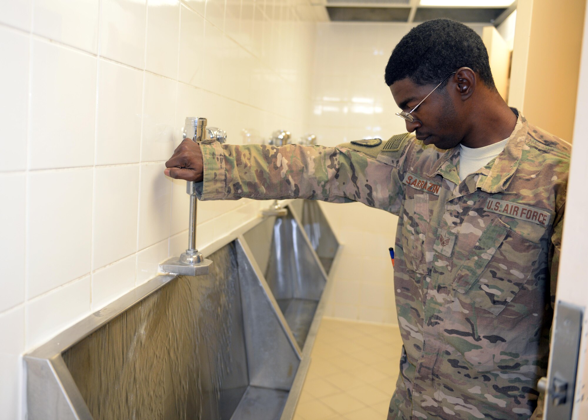 U.S. Air Force Staff Sgt. Stark Sarrazin, 455th Expeditionary Civil Engineer Squadron non-commissioned officer in charge of water and fuels systems maintenance, flushes a water system in a dormitory Aug. 27, 2015, at Bagram Airfield, Afghanistan. Sarrazin is one of three Airmen responsible for maintaining the fuel line on the airfield as well as quality of life of some living quarters on base and a few facilities that are not yet contracted. (U.S. Air Force photo by Senior Airman Cierra Presentado/Released)