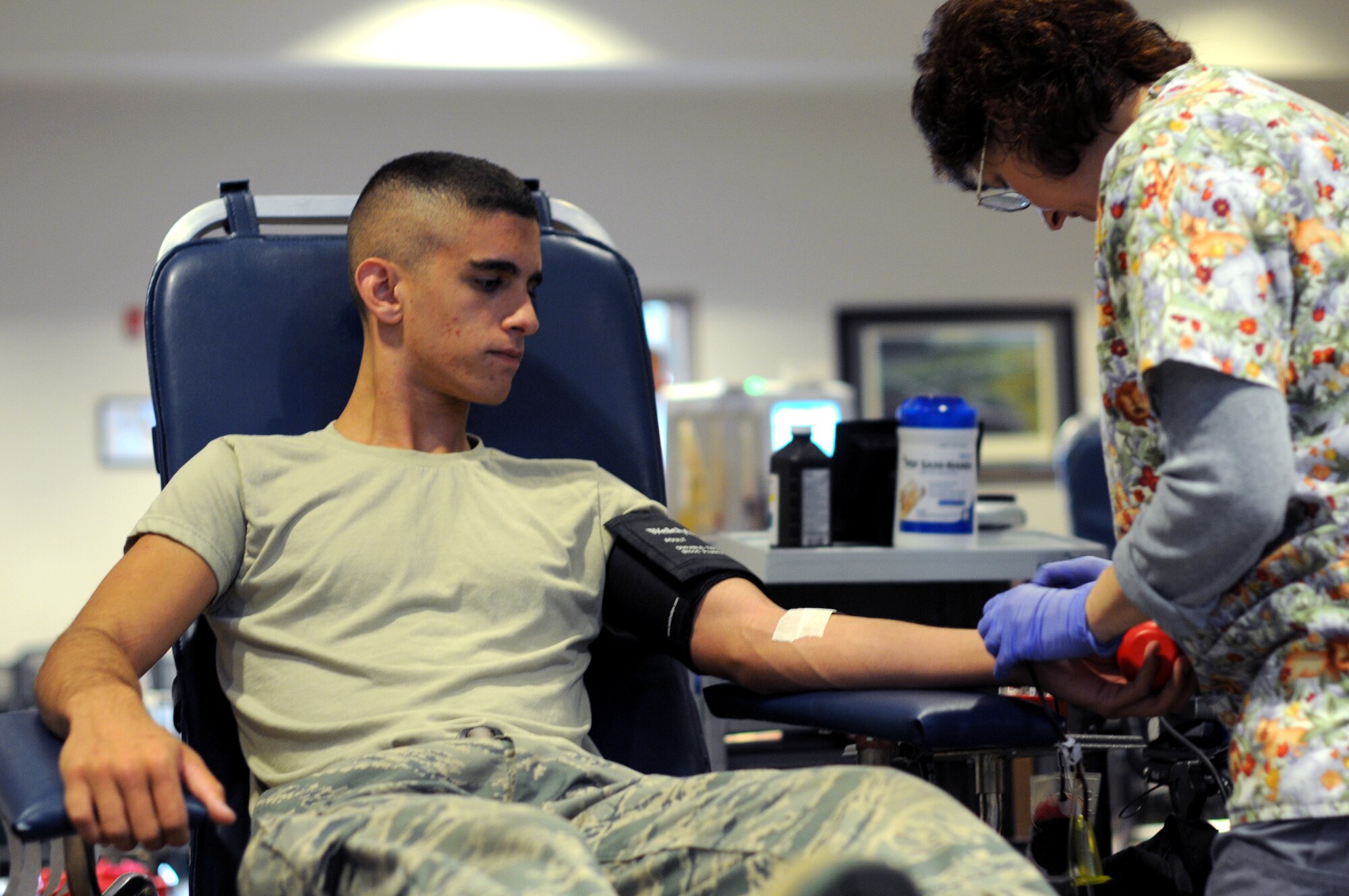 A picture of U.S. Air Force Airman 1st Class Matthew Baruffi, an egress technician from the New Jersey Air National Guard's 177th Fighter Wing, giving blood during a blood drive.