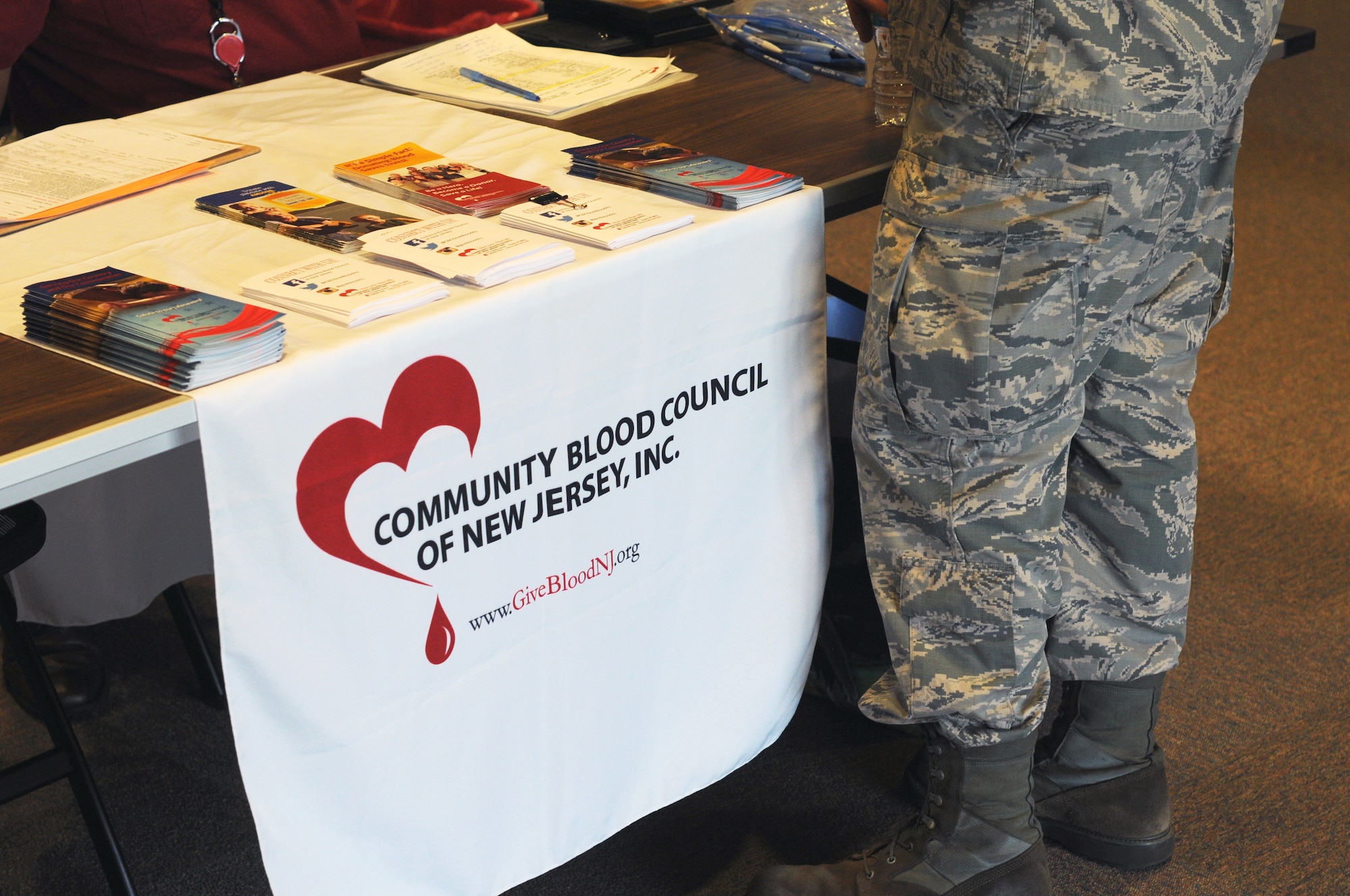 A picture of an Airman from the New Jersey Air National Guard's 177th Fighter Wing approaching the sign-in desk for a blood drive.