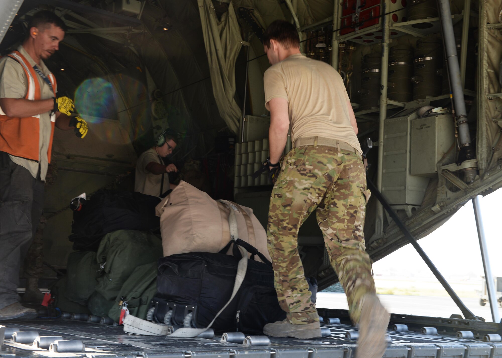 U.S. Air Force Staff Sgt. Casey Strauss, 774th Expeditionary Airlift Squadron C-130J Super Hercules aircraft loadmaster, moves luggage onto an aircraft Aug. 28, 2015, at Bagram Airfield, Afghanistan. Strauss and his fellow loadmasters are responsible for loading and unloading cargo, passenger safety in flight, and ensuring the aircraft stays within the proper weight and balance limitations. (U.S. Air Force photo by Senior Airman Cierra Presentado/Released)