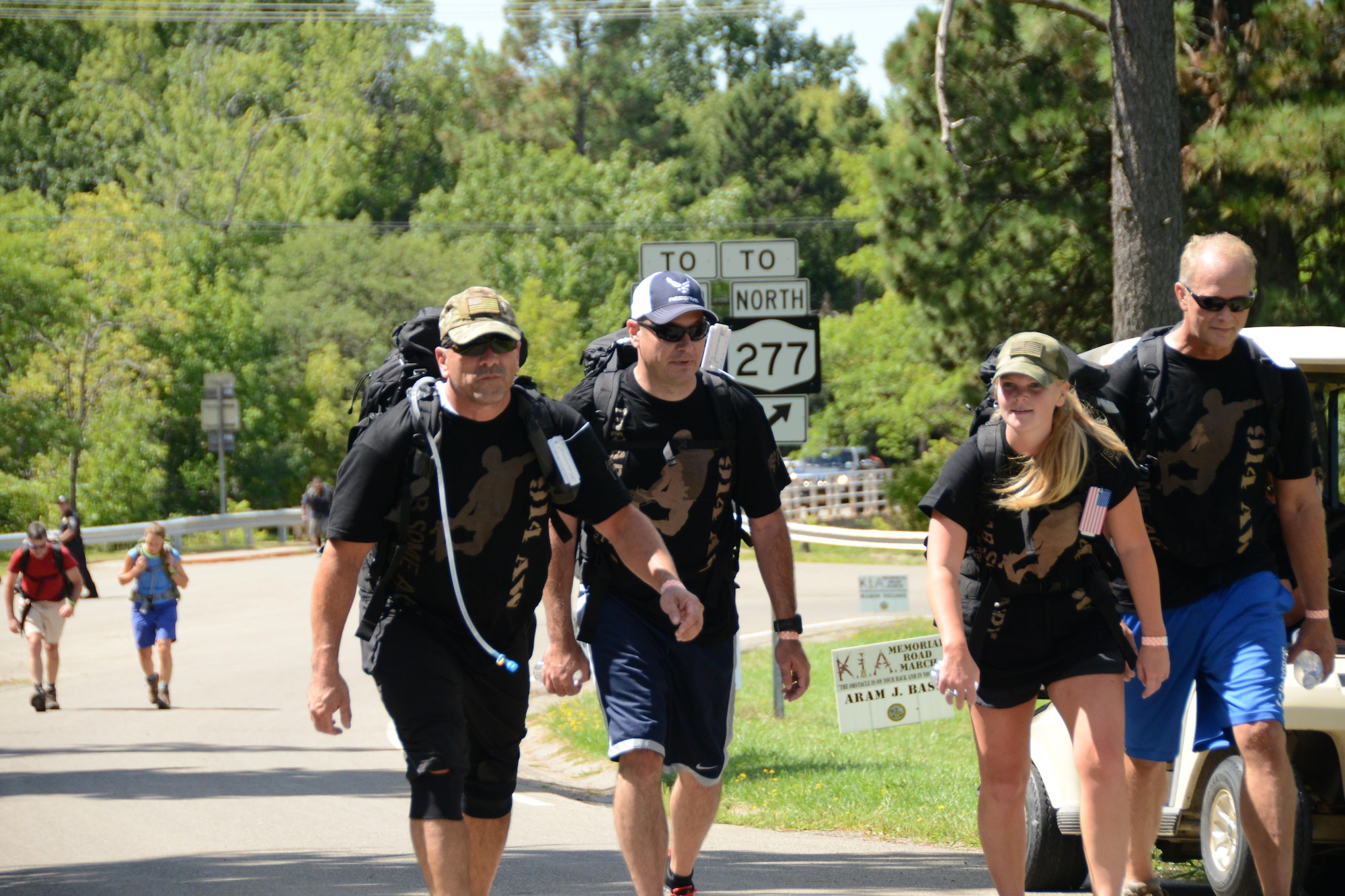 Senior Master Sgt. Steve Brown, Chief Master Sgt. Clint Ronan, Master Sgt. Hillary Harter and Col. Steven Parker participate in the KIA Memorial Road March at Chestnut Ridge State Park, Orchard Park, N.Y. August 22, 2015. Members of the 914th Airlift Wing participated in this 10K marching event carrying canned goods which were donated to local veteran organizations; all this in memory of Western New York veterans killed during the Global War on Terror. (U.S. Air Force photo by Tech. Sgt. Andrew Caya)