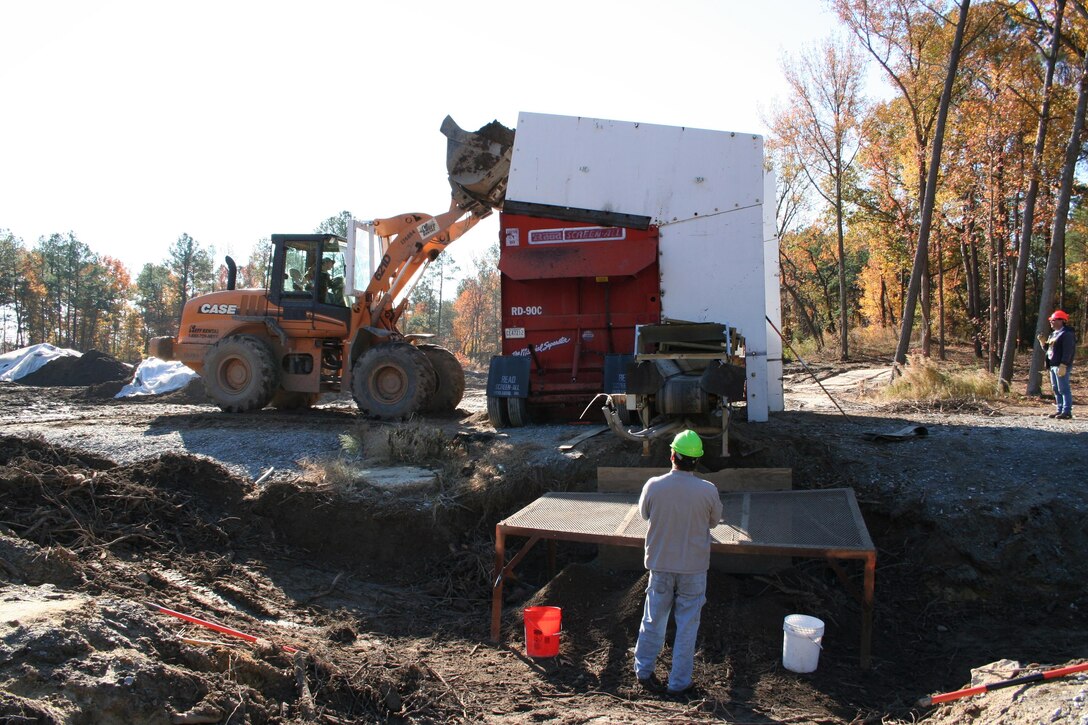 SUFFOLK, Va. -- Contractors sort through the dirt at the Former Nansemond Ordance Depot, looking for buried ordnance. In 1987 the Former Nansemond Ordnance Depot  became a matter of public concern when a piece of crystalline TNT was found at the Tidewater Community College, Portsmouth Campus. Extensive historical research, investigations, and testing led the U.S. Environmental Protection Agency to place this site on the National Priority list in 1999. The U.S. Army Corps of Engineers has managed the clean-up project on this site since. (U.S. Army photo/Patrick Bloodgood)