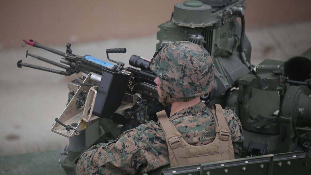 A Marine with Charlie Company, 1st Battalion, 8th Regiment, operates an M240B medium machine gun turret atop a Humvee during a field exercise aboard Camp Lejeune, N.C., Aug. 25, 2015. Marines assaulted a simulated town, set up a defensive position and waited to repel simulated attacks in preparation for their upcoming deployment with Special Purpose Marine Air Ground Task Force Crisis Response. 
