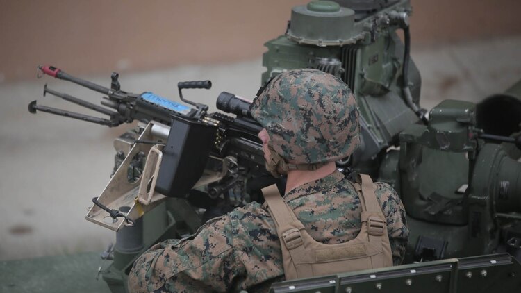 A Marine with Charlie Company, 1st Battalion, 8th Regiment, operates an M240B medium machine gun turret atop a Humvee during a field exercise aboard Camp Lejeune, N.C., Aug. 25, 2015. Marines assaulted a simulated town, set up a defensive position and waited to repel simulated attacks in preparation for their upcoming deployment with Special Purpose Marine Air Ground Task Force Crisis Response. 